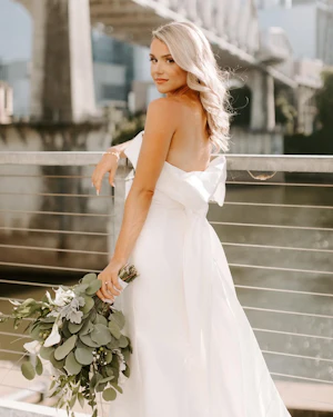 Bride Wearing Unique Strapless Wedding Dress With Beautiful Back Bow Mitchell By Maggie Sottero