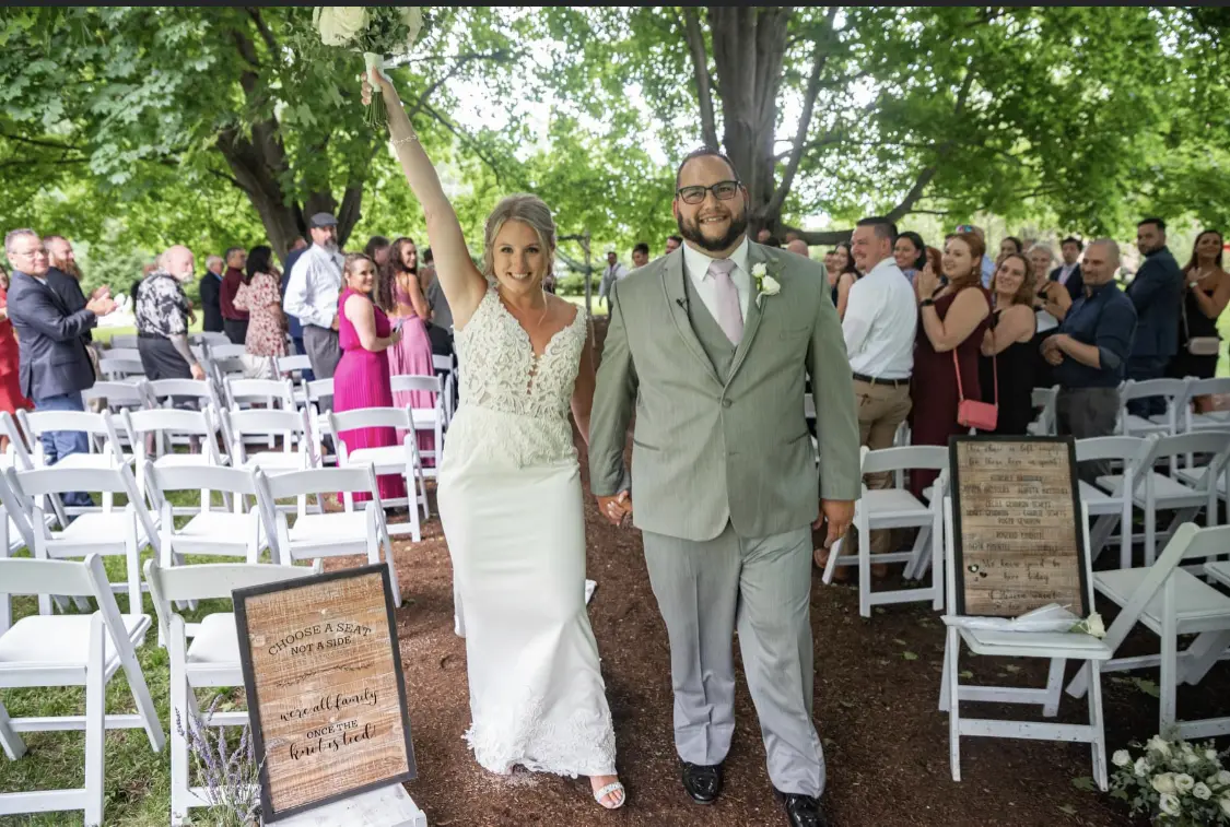 Bride with groom wearing lace crepe wedding dress