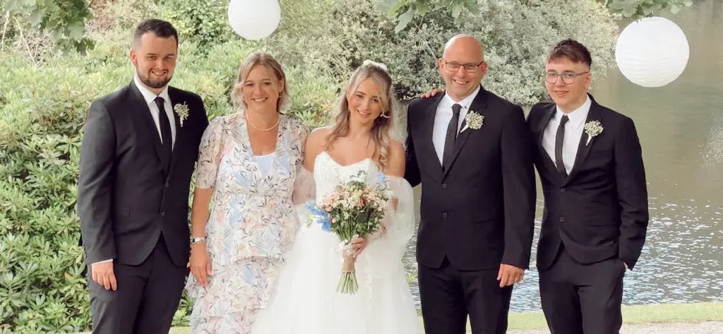 Real Bride in V-Back and Corset Detail Wedding Dress Named Harlem by Maggie Sottero with Family