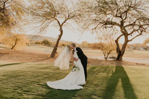 Groom Kisses Bride Wearing Elegant Mermaid Dress Fredrique by Maggie Sottero
