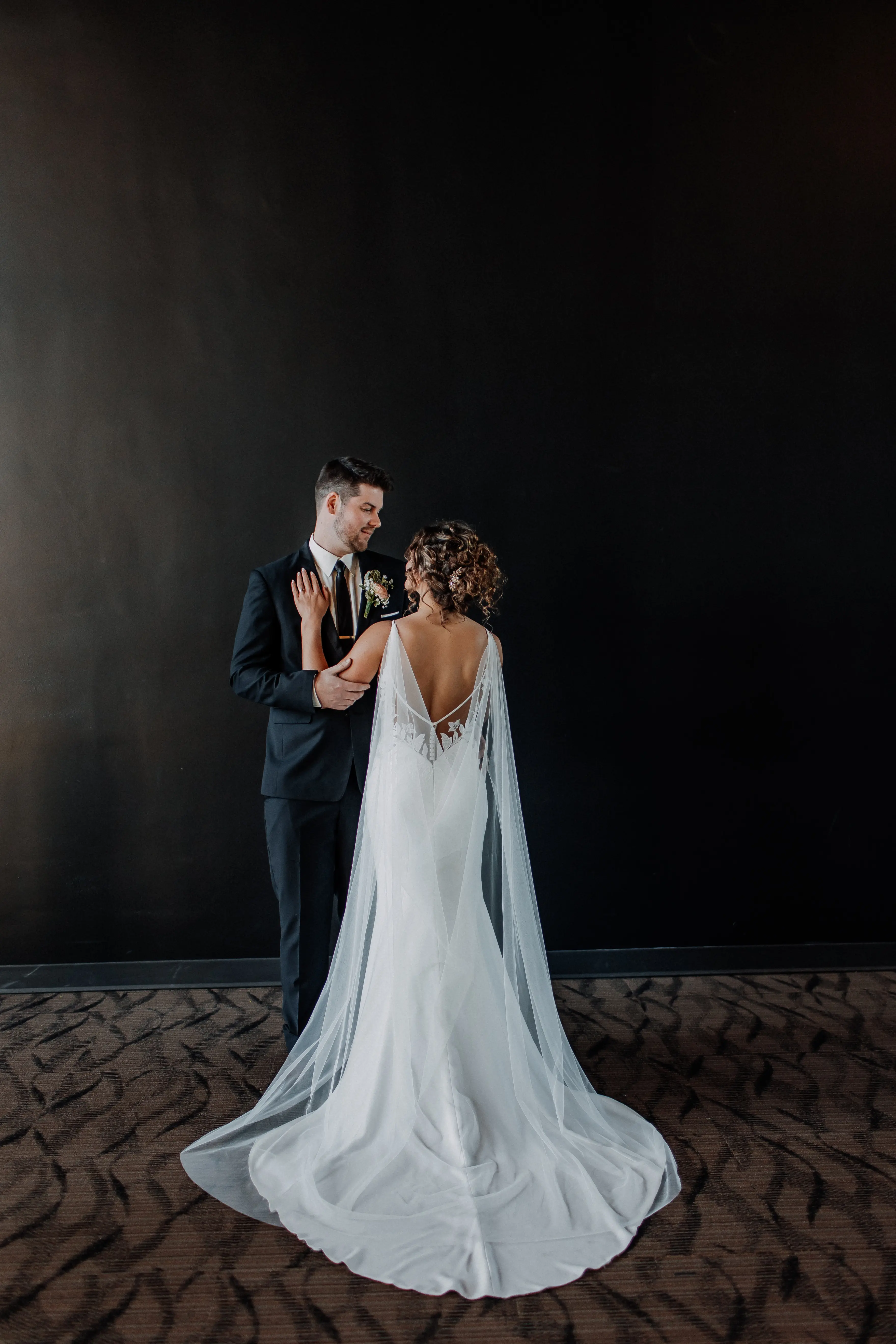 Bride wearing Dionne by Rebecca Ingram standing with her husband