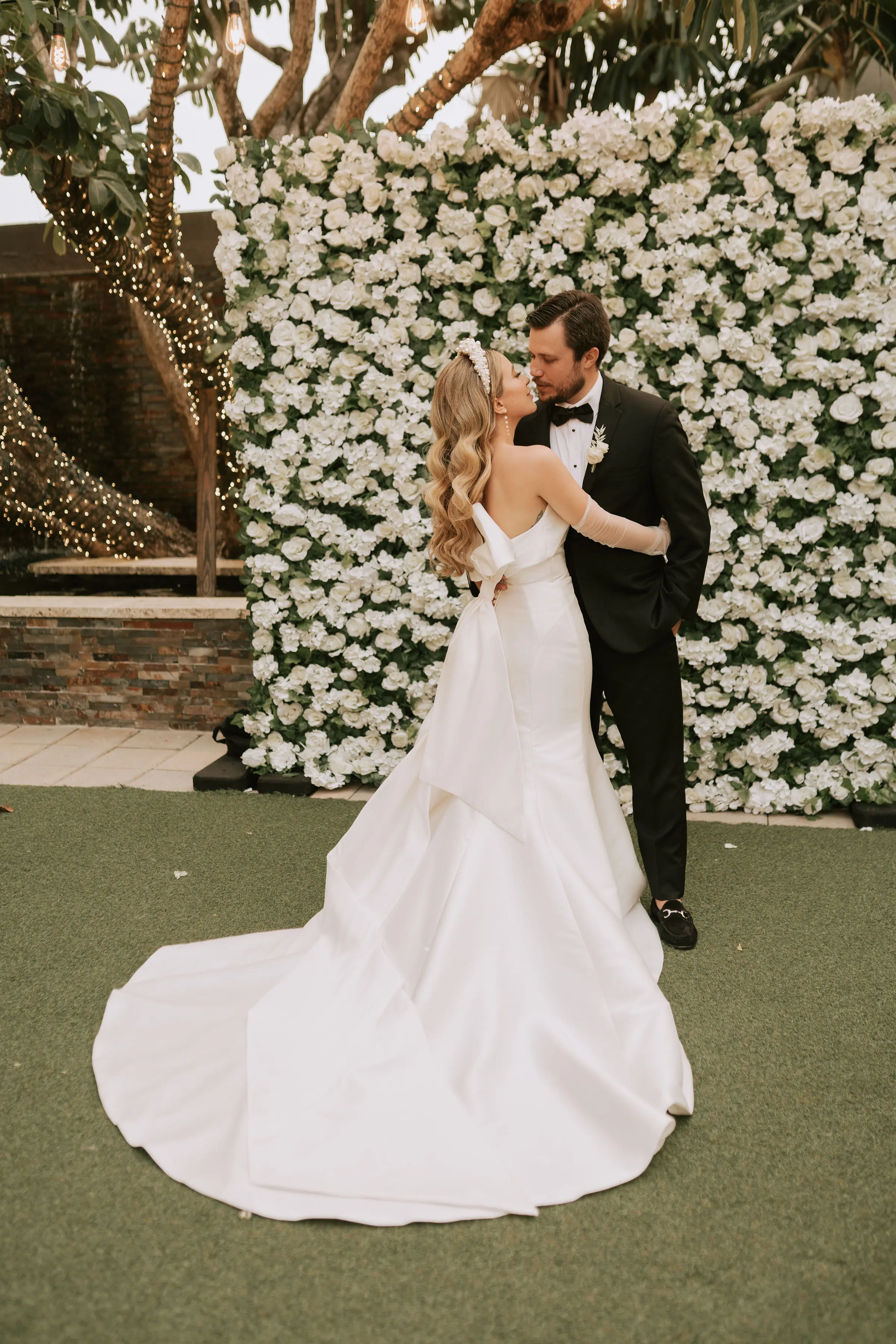 Groom With Bride Wearing Simple Sheath Satin Dress With Back Bow Mitchell By Maggie Sottero