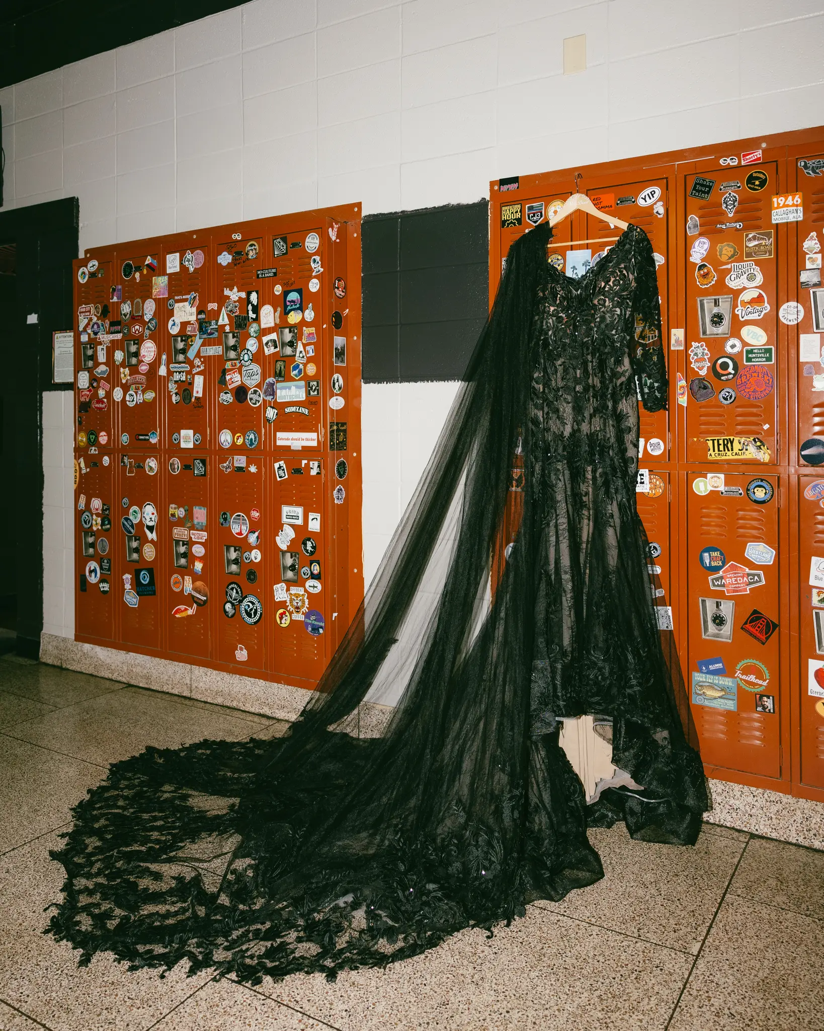 Black Lace Wedding Dress Called Zander Lane By Sottero And Midgley Hanging From Some Lockers