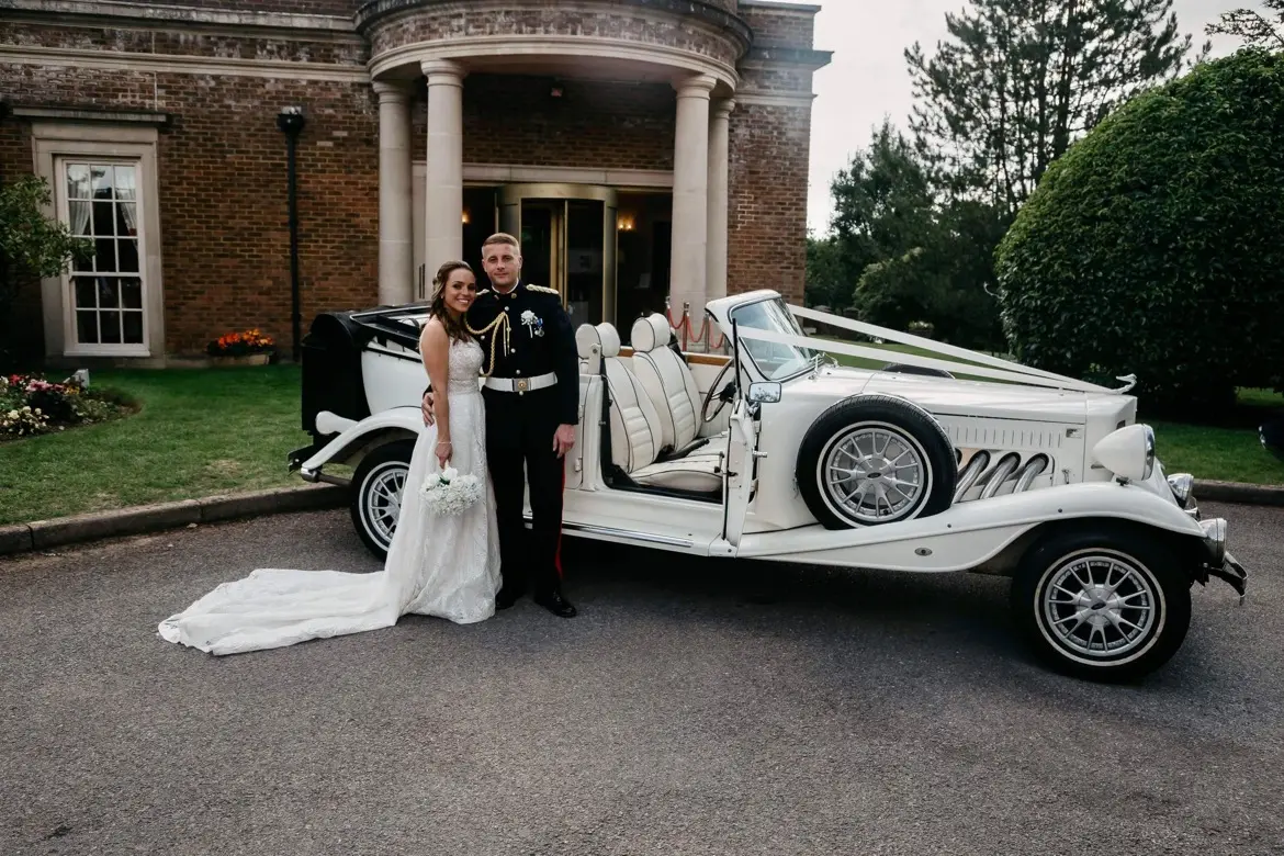 Bride Wearing Boho Lace Wedding Dress Called Roxanne By Sottero And Midgley With Groom Next To A Vintage Car