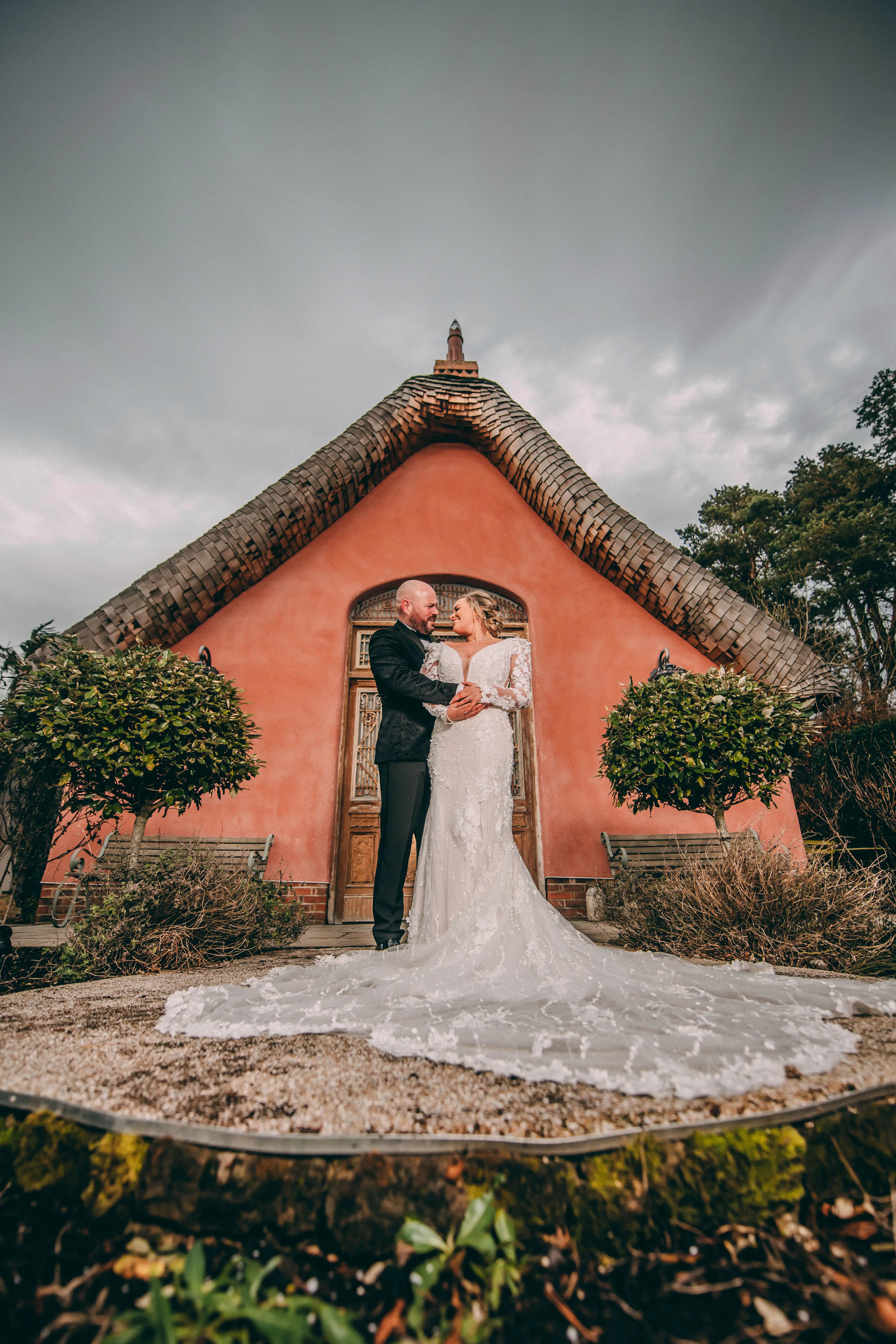 Groom With Bride Wearing Vintage Mermaid Wedding Dress With 3-D Floral Motifs Cruz By Sottero And Midgley