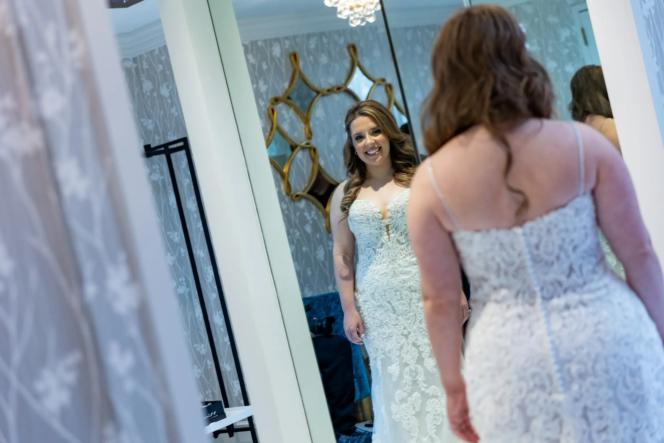 Bride Wearing Lace Fit-And-Flare Wedding Dress Called Fiona By Maggie Sottero Looking In A Mirror