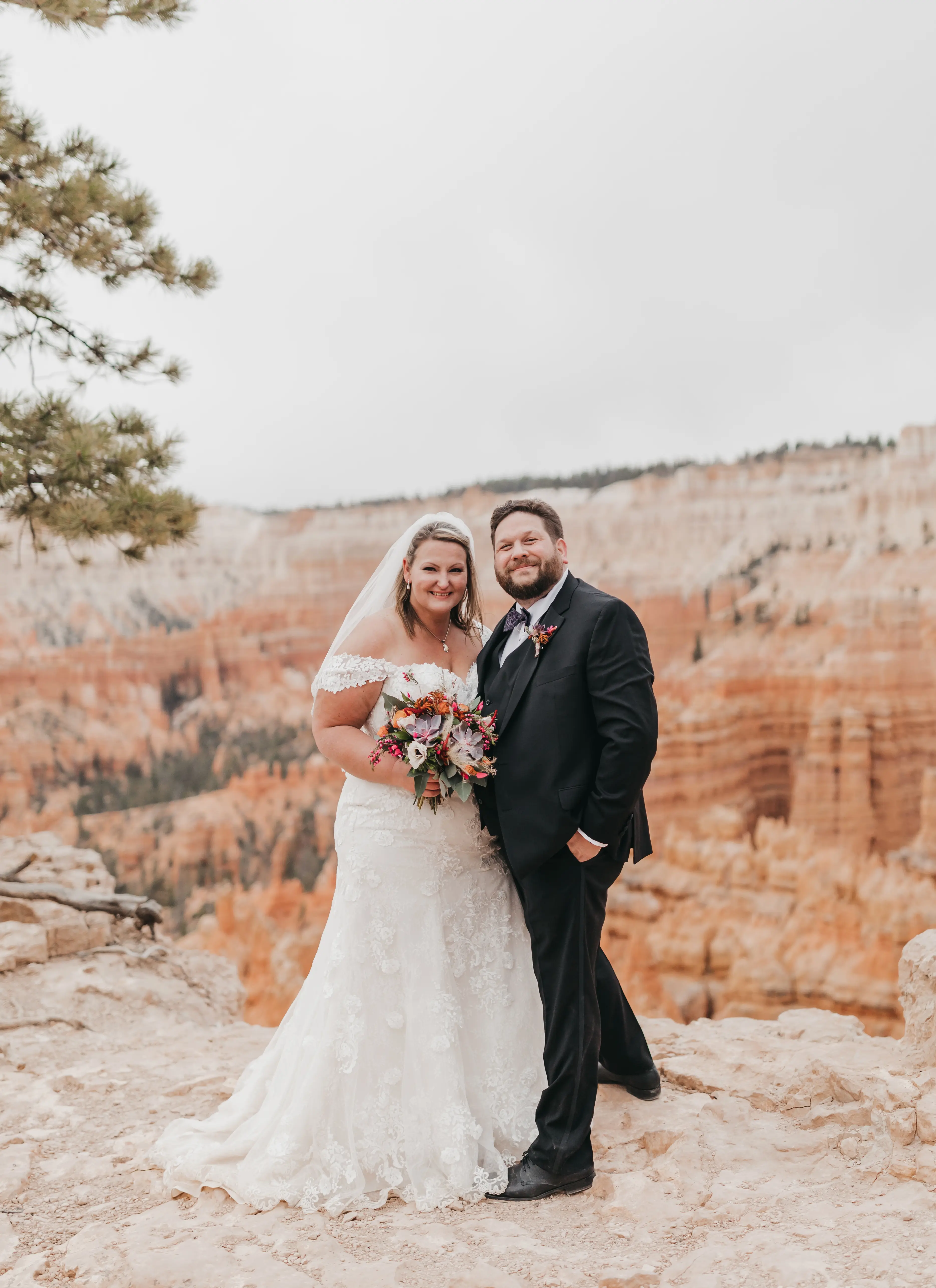 bride with groom in corset back fit and flare wedding dress