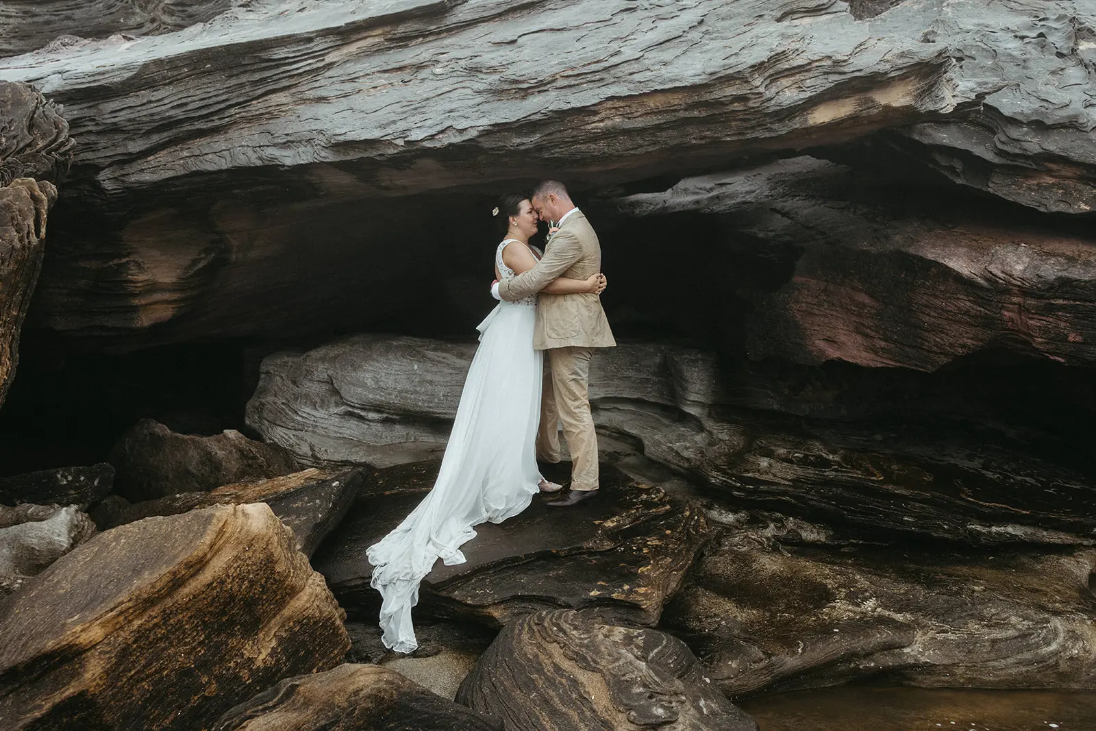 Bride with groom wearing boho wedding dress with keyhole back.