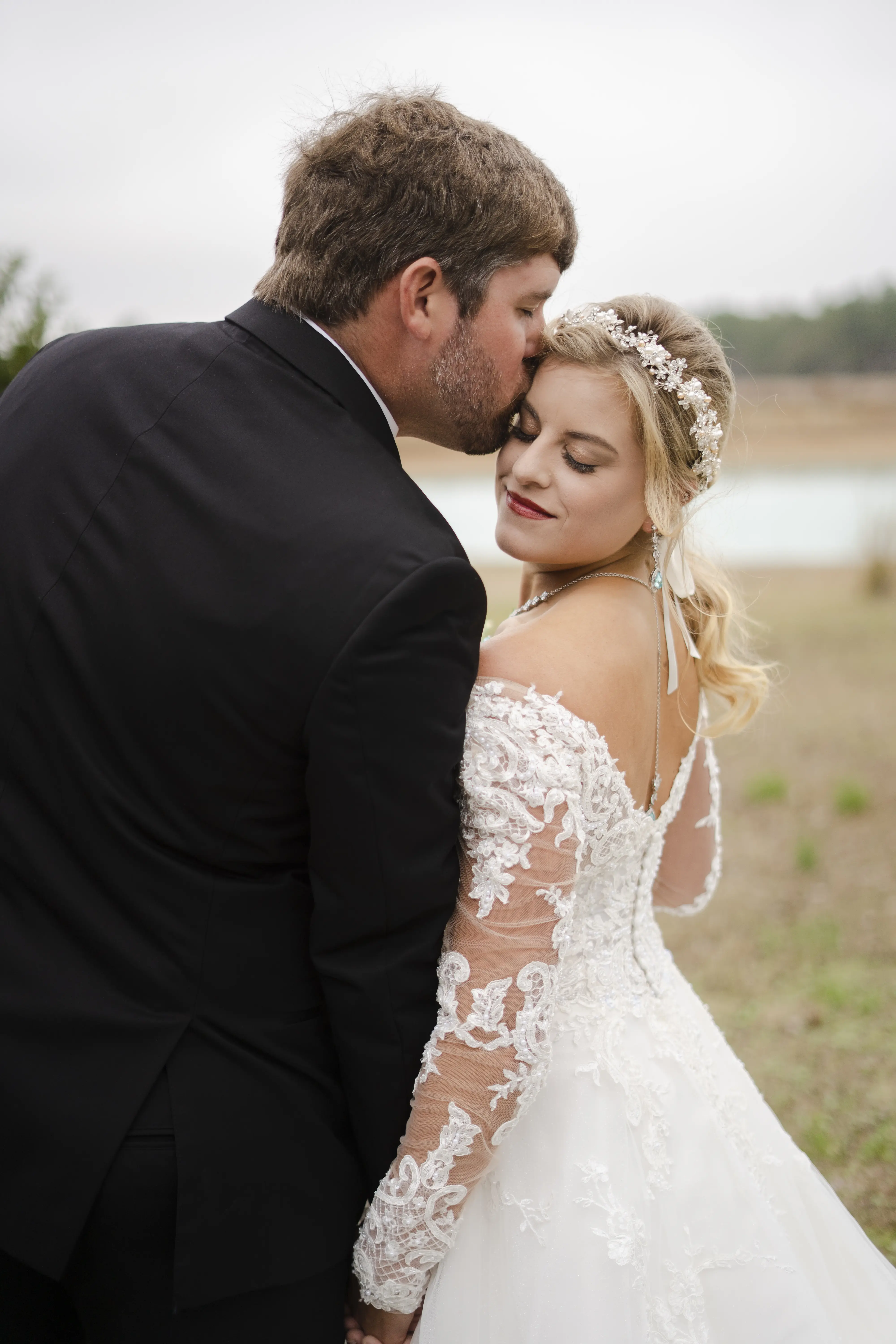 Bride In Off The Shoulder Lace Wedding Dress Called Tiffany By Maggie Sottero With Groom