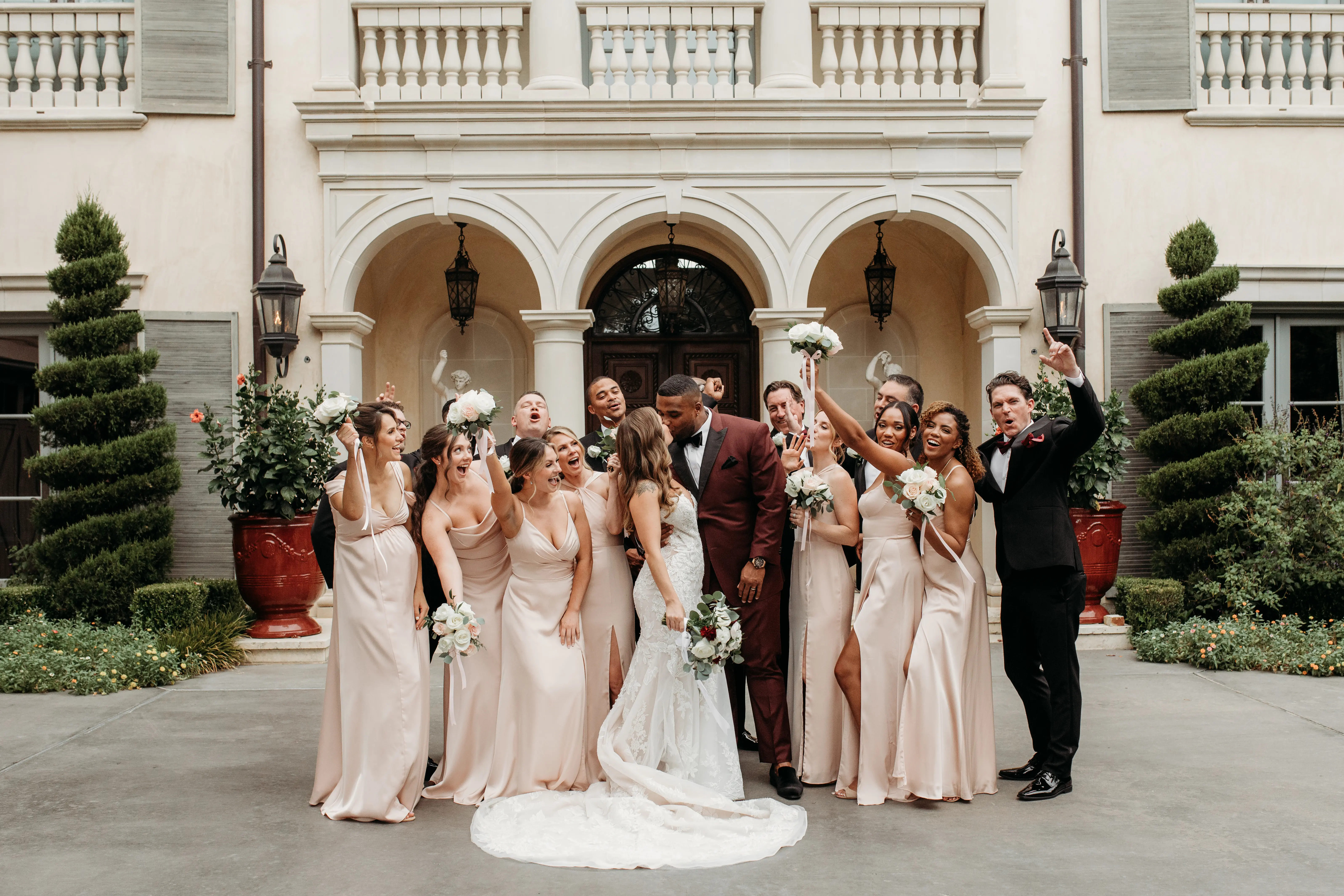 Groom and Bride Wearing Lace Mermaid Wedding Gown Called Montgomery By Sottero and Midgley With Wedding Party