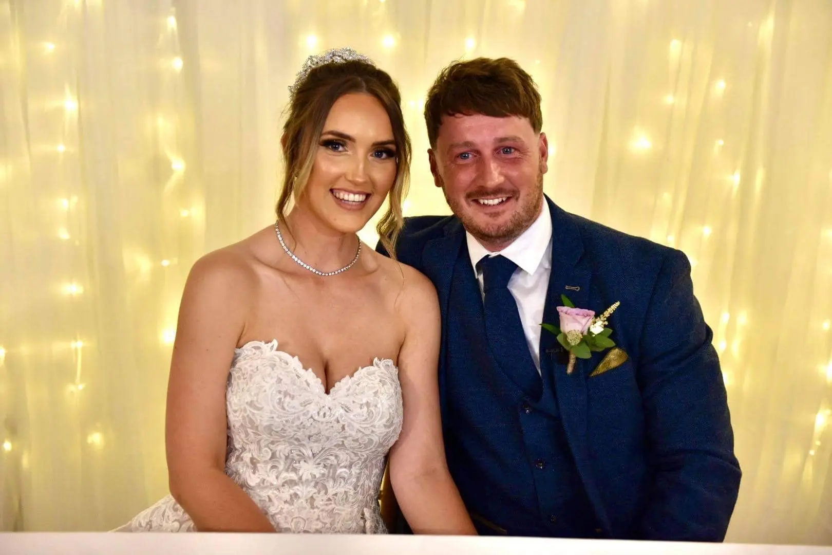 bride with groom in lacy mermaid wedding dress
