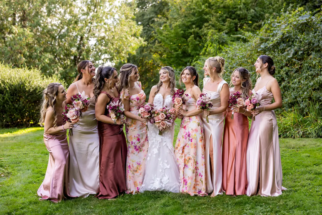 Bride wearing Hattie Marie by Rebecca Ingram laughing with her bridesmaids