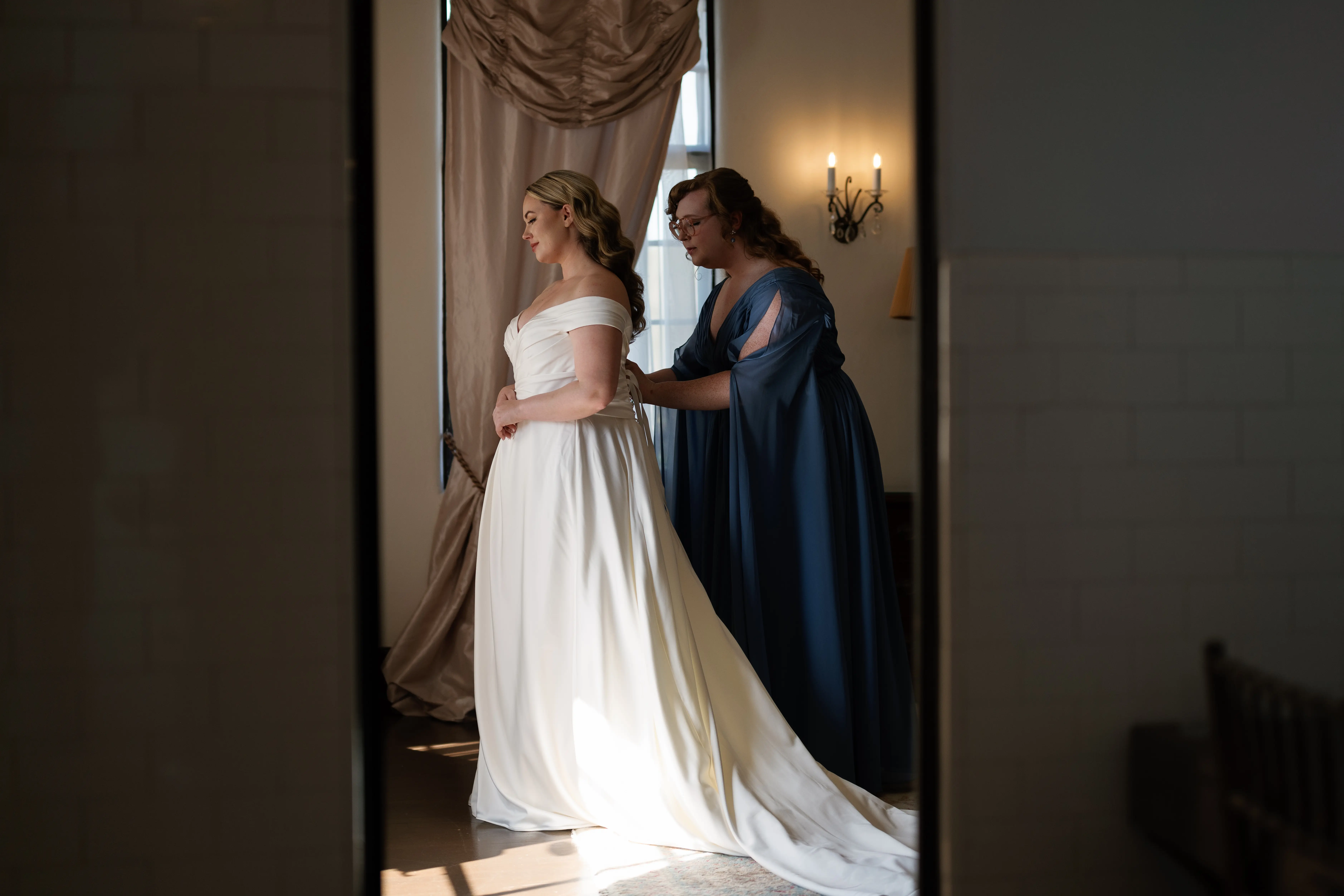 Bride wearing Ekaterina by Maggie Sottero getting zipped up