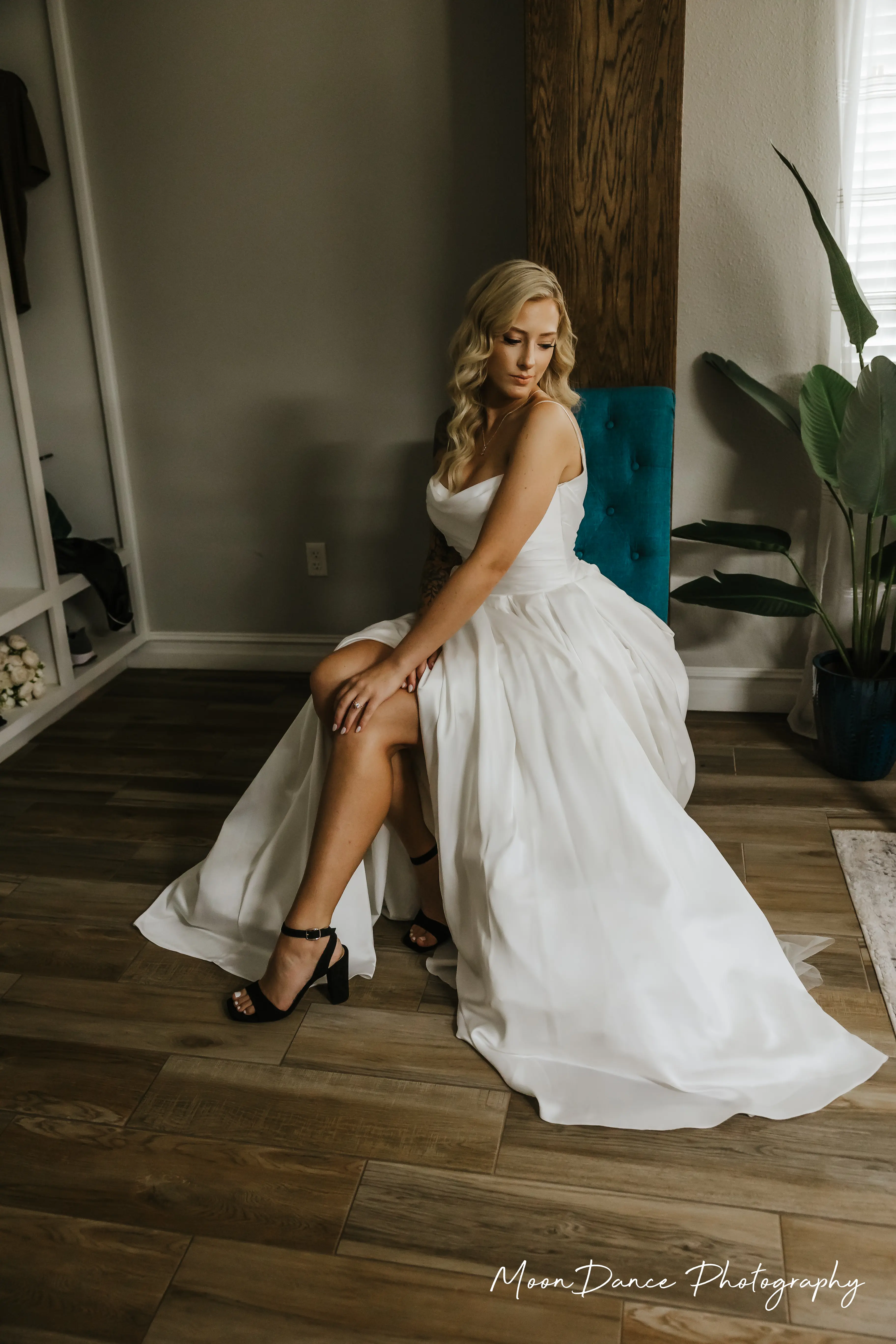 Bride Wearing Aline Satin Wedding Gown Called Scarlet By Maggie Sottero Sitting On A Teal Chair
