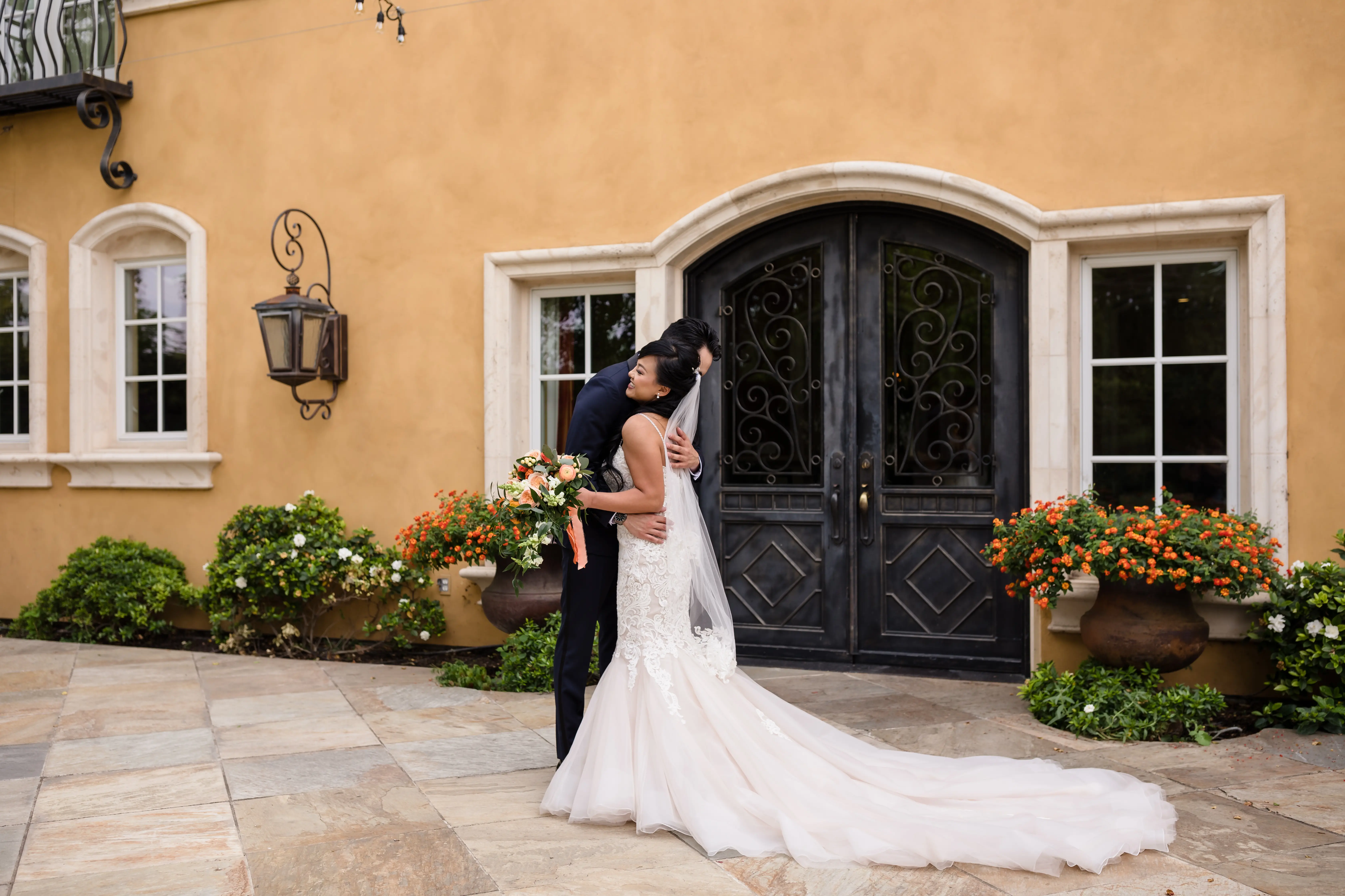Bride Wearing Lace Fit and Flare Wedding Dress by Maggie Sottero Bride Hugging Groom