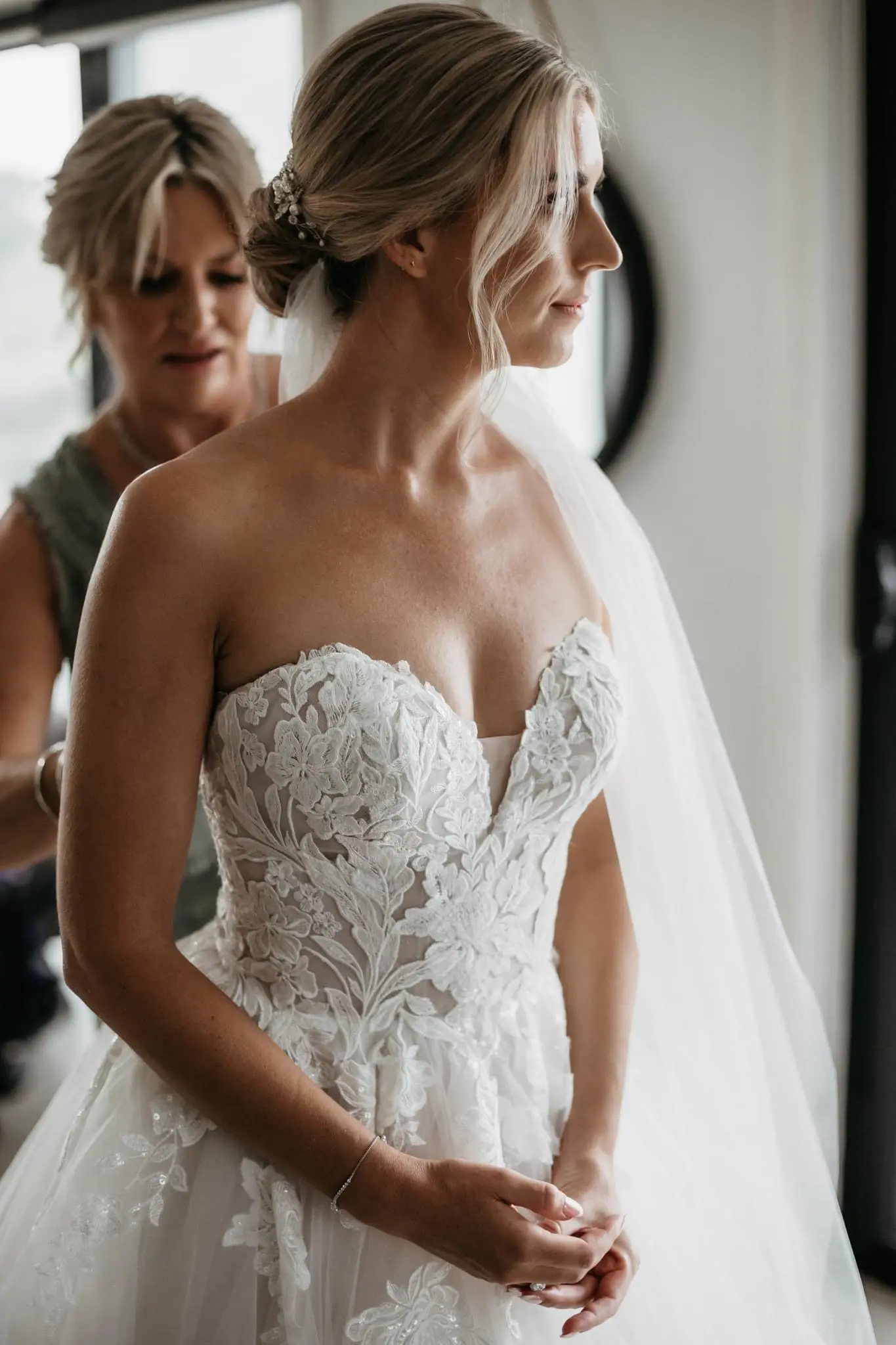 Bride wearing Indiana by Maggie Sottero being zipped up