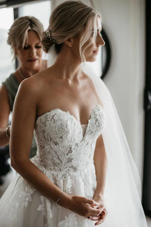 Bride wearing Indiana by Maggie Sottero being zipped up