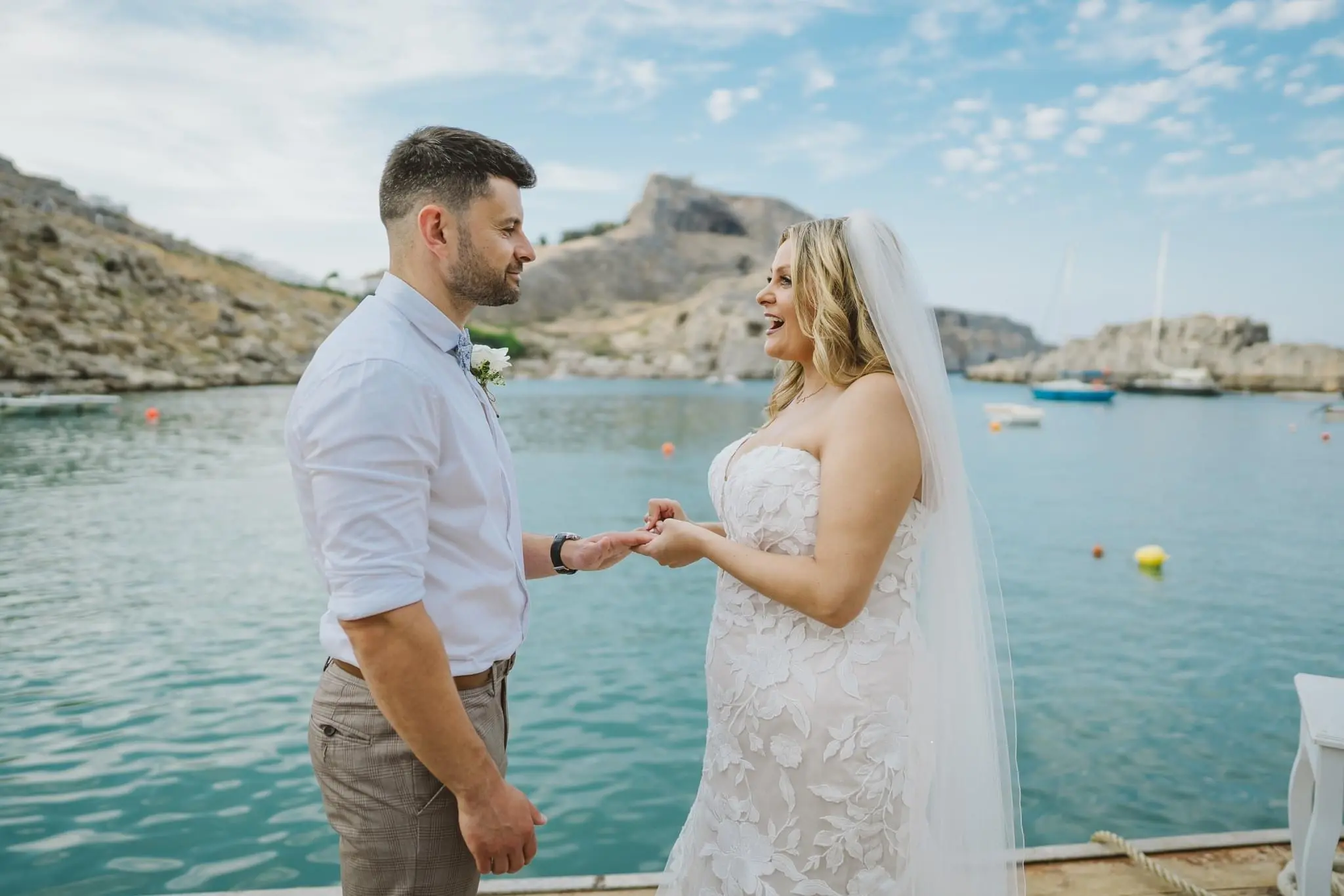 Bride wearing Hattie wedding dress by Rebecca Ingram exchanging rings with her husband