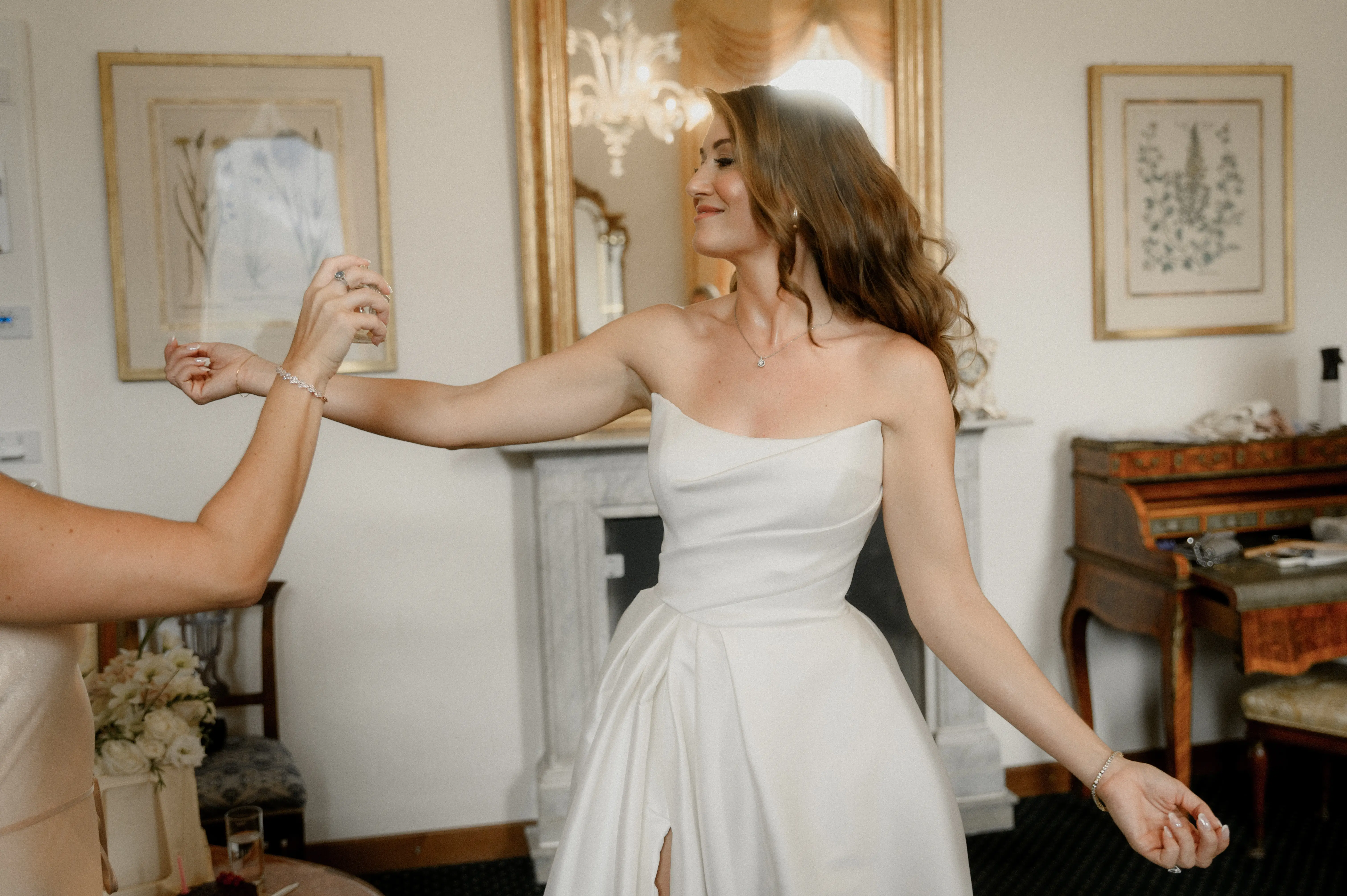 Bride wearing Aspen by Sottero and Midgley putting on perfume