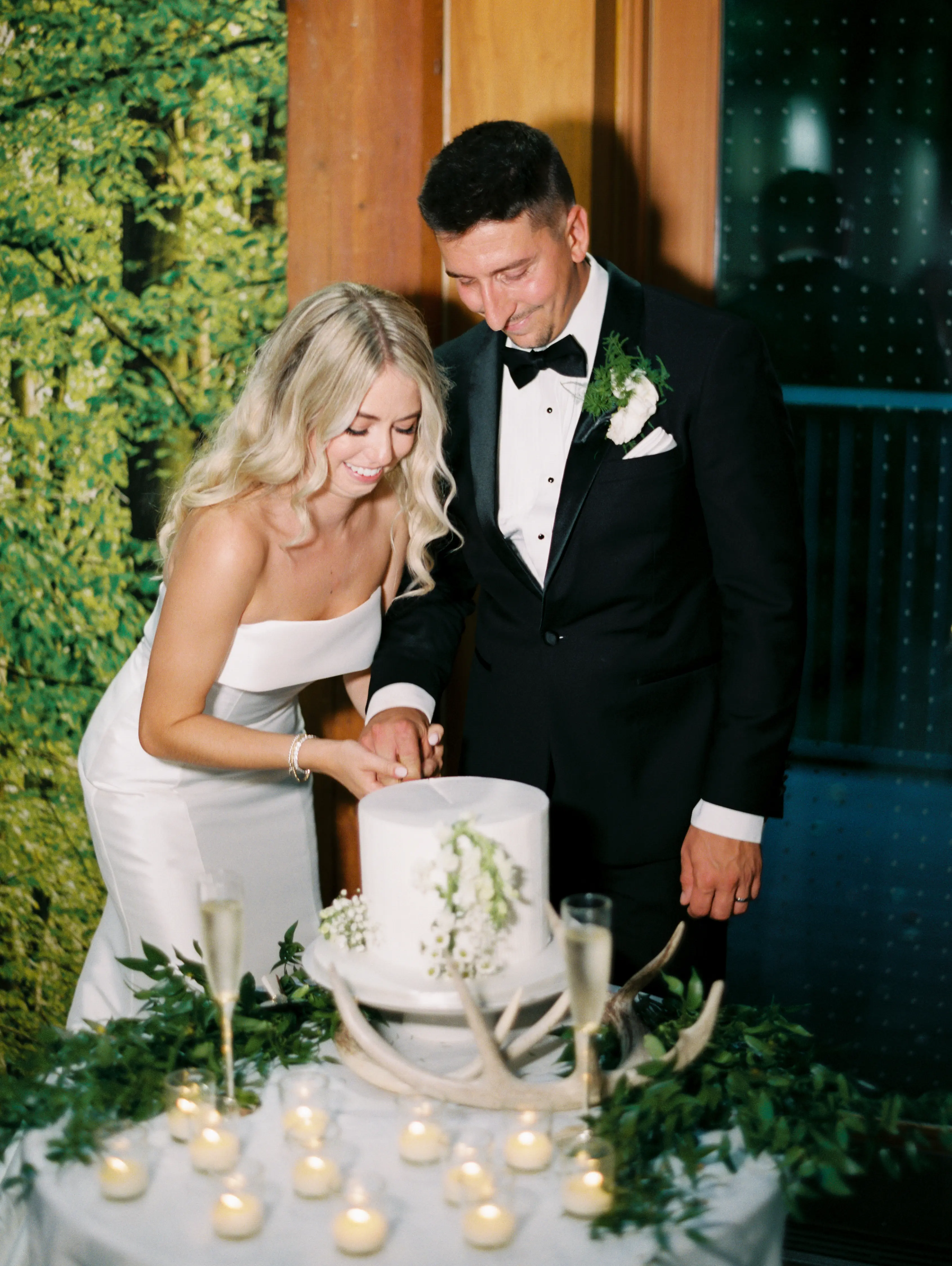 Bride Wearing Simple Fit And Flare Wedding Dress Called Mitchell Marie By Maggie Sottero Cutting The Cake With Groom