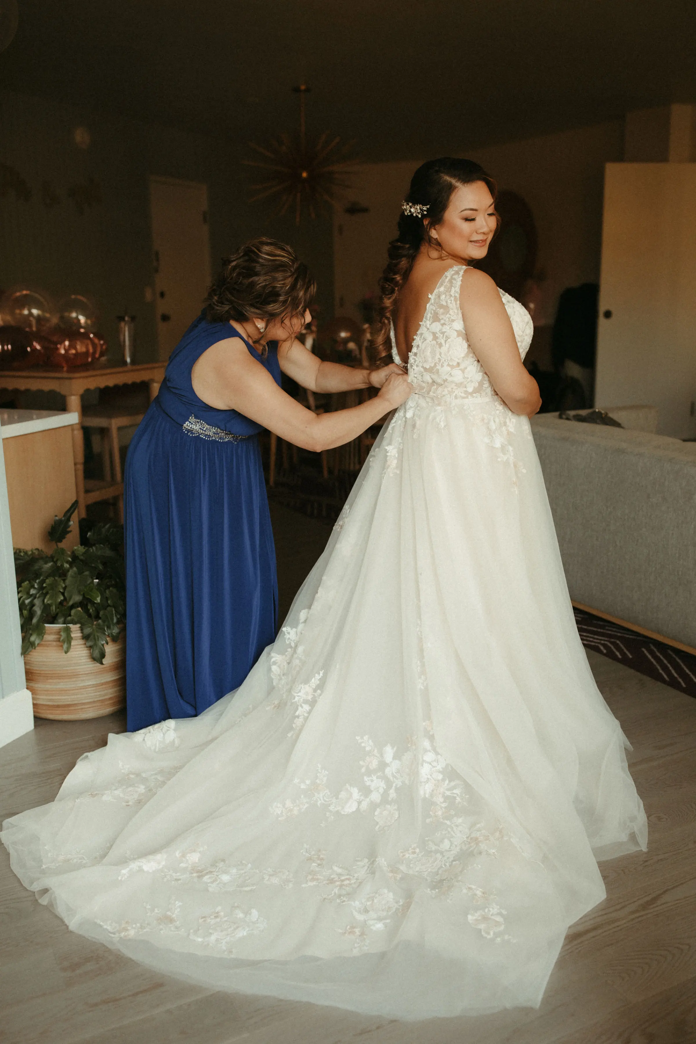 Bride wearing affordable A-Line floral motif wedding dress.