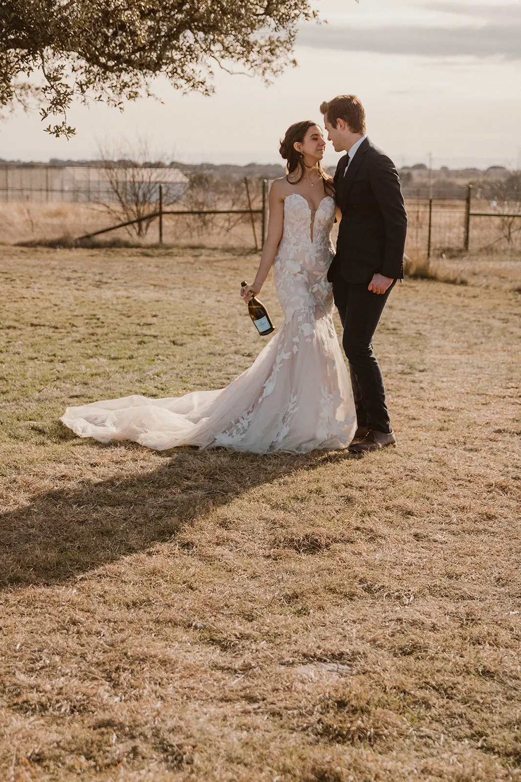 Bride wearing Bridget by Maggie Sottero drinking with her husband
