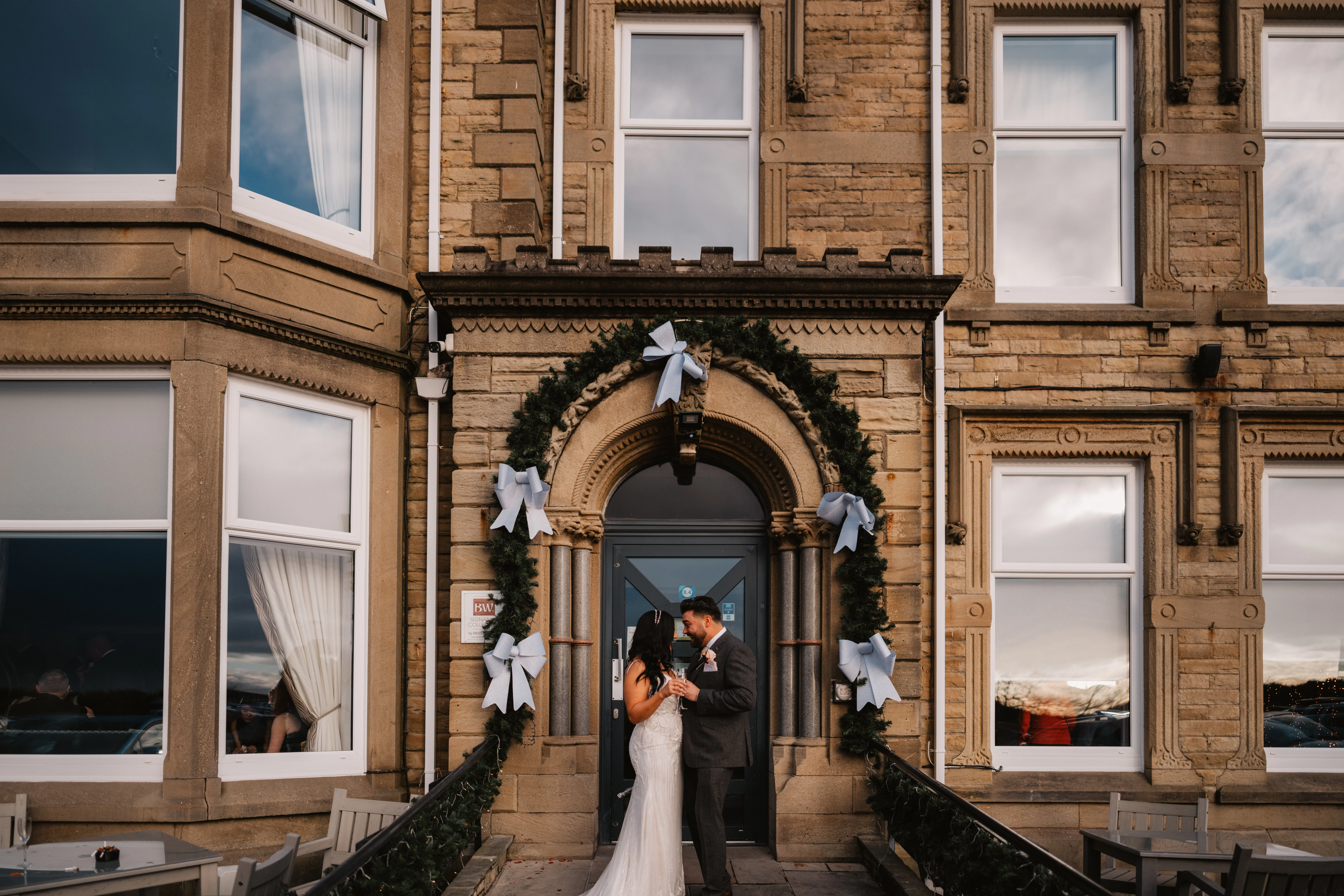 Bride Wearing Art Deco Wedding Dress Called Luella By Sottero And Midgley With Groom On A Porch