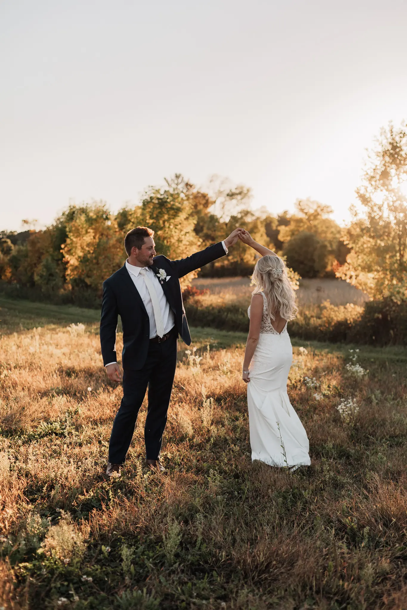 Newlyweds dancing at sunset.