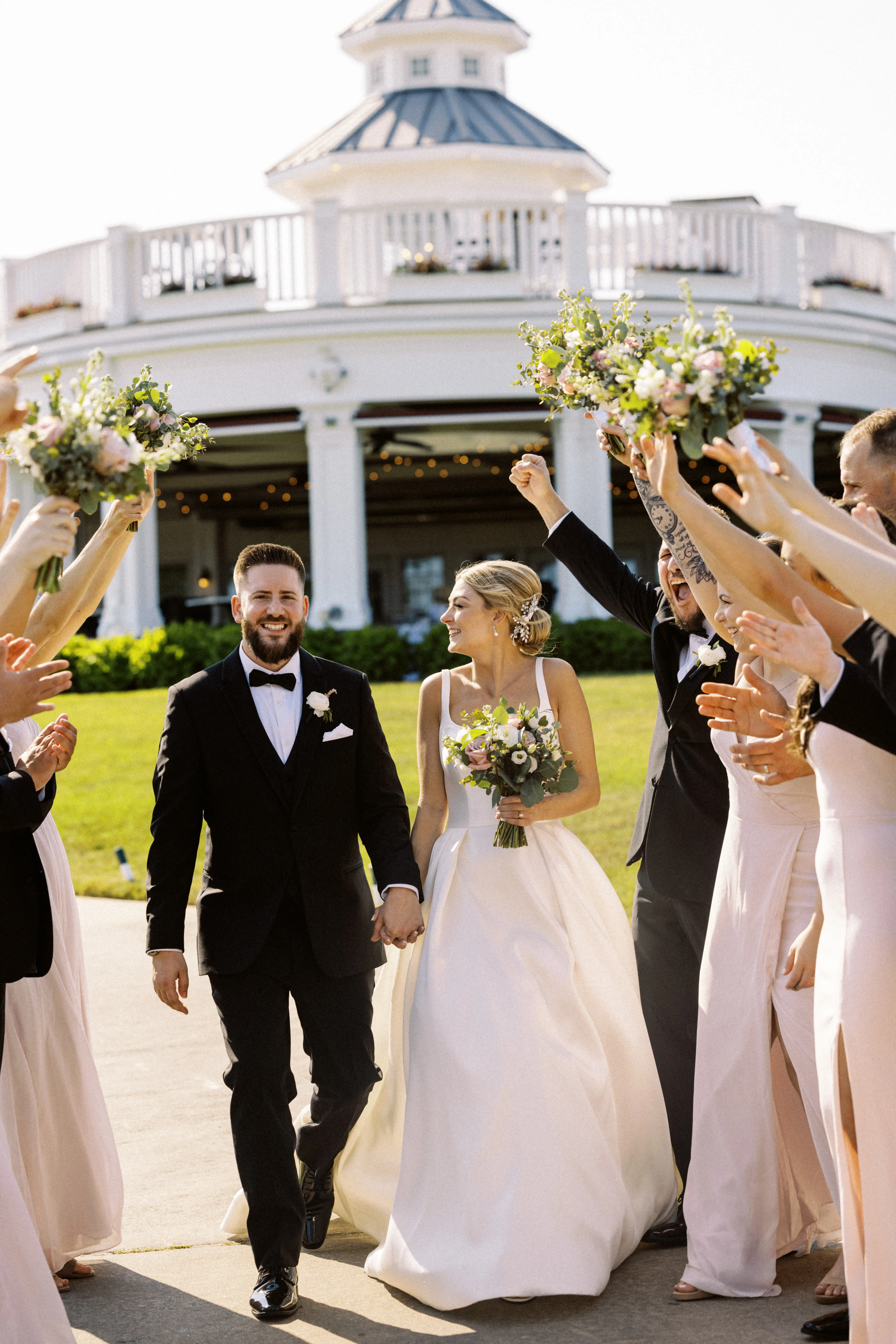 Bride wearing Selena wedding dress by Maggie Sottero celebrating with her husband and bridal party