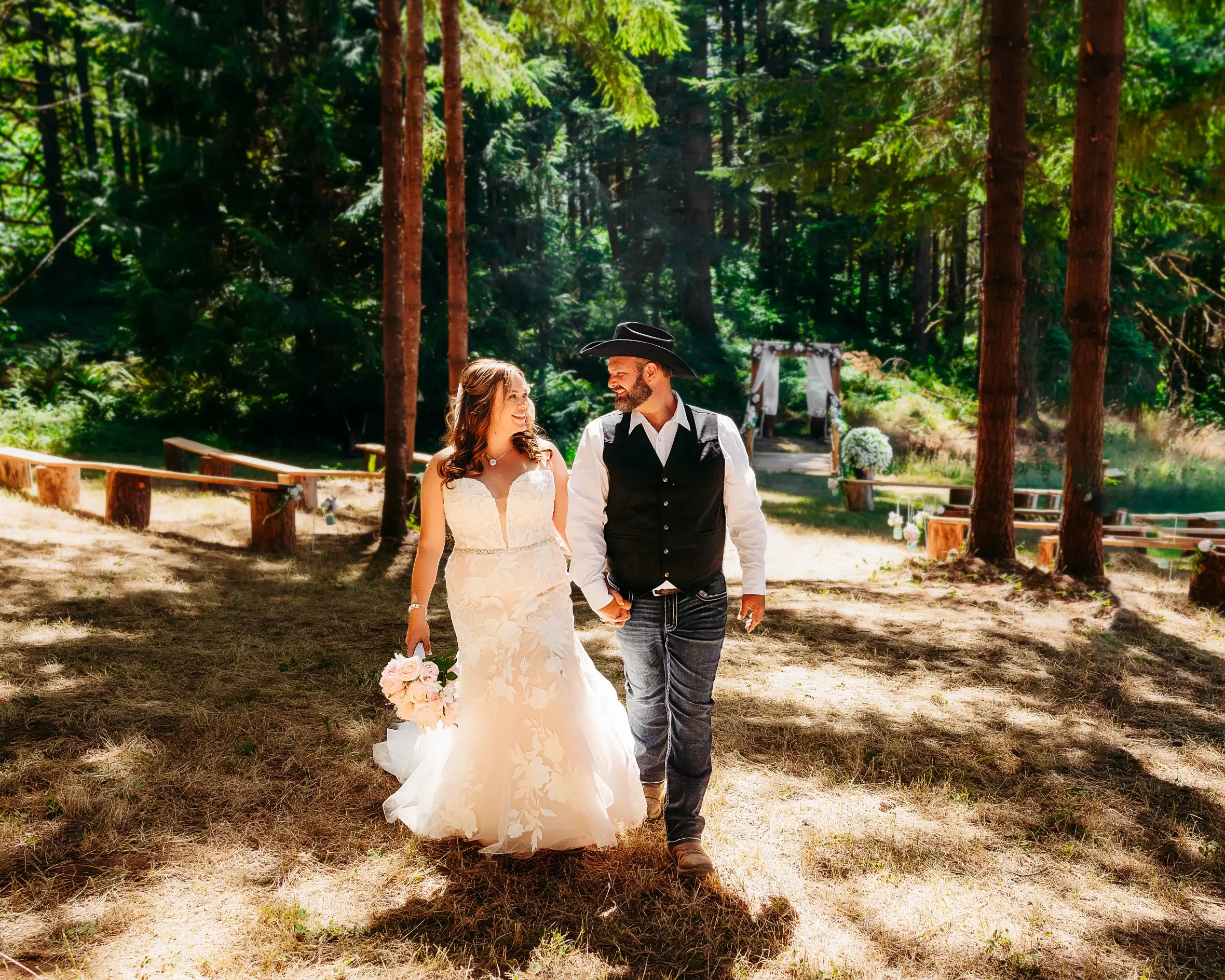Bride wearing Hattie wedding dress by Rebecca Ingram holding hands with her husband