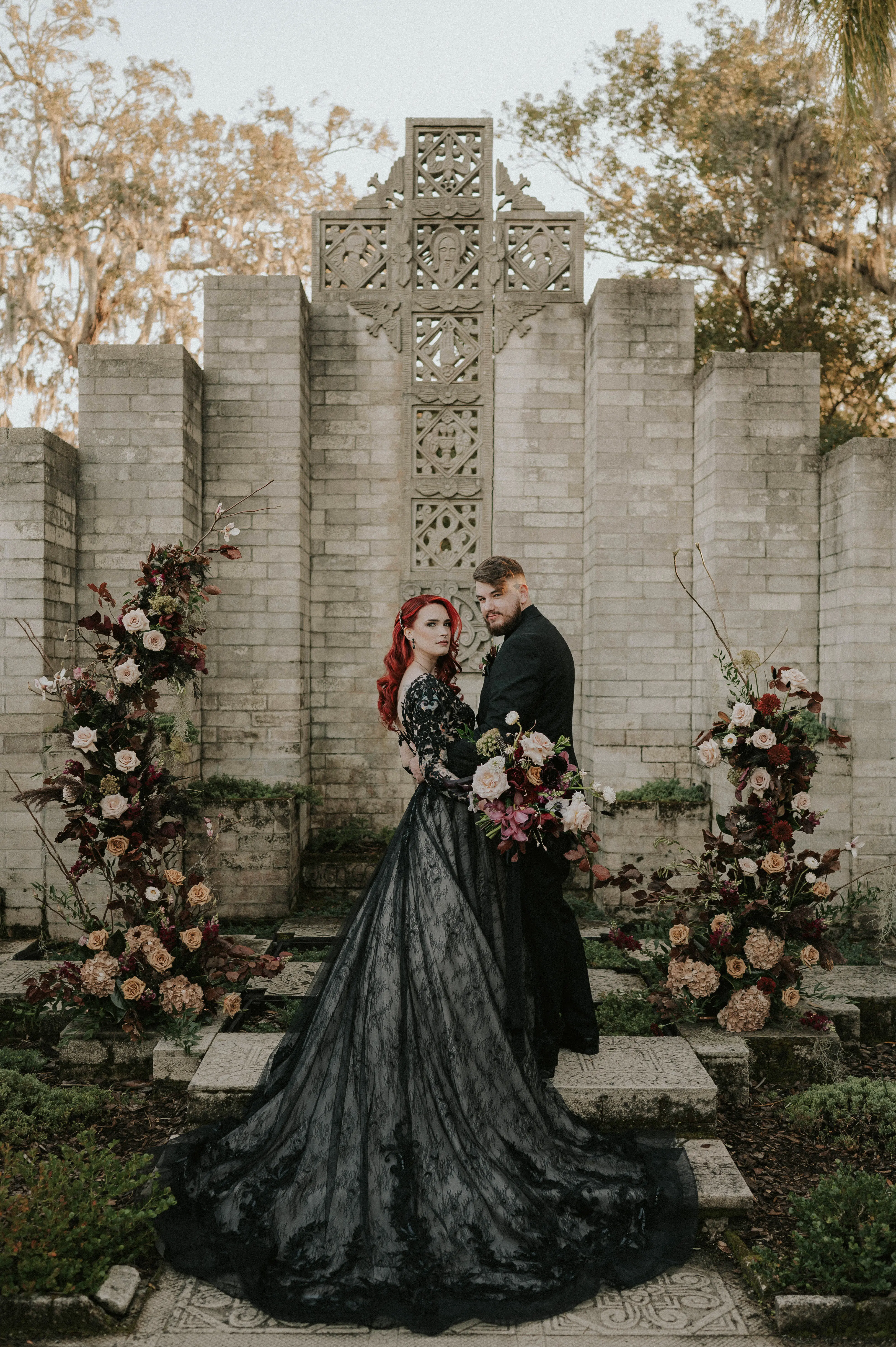 Red Head Bride In Black Wedding Dress Called Zander By Maggie Sottero With Floral Arch And Groom In Black