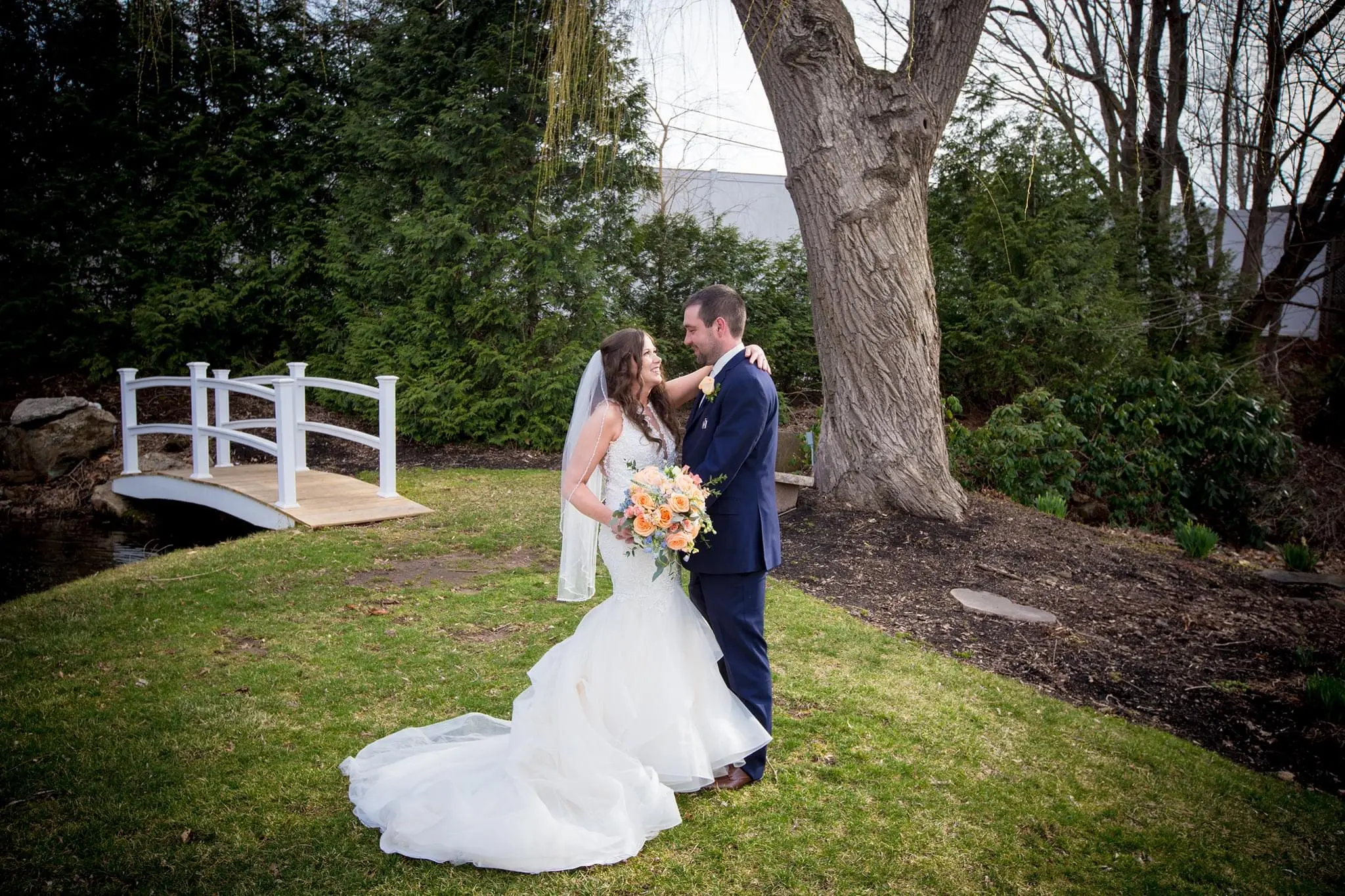 Bride with groom wearing organza mermaid wedding dress