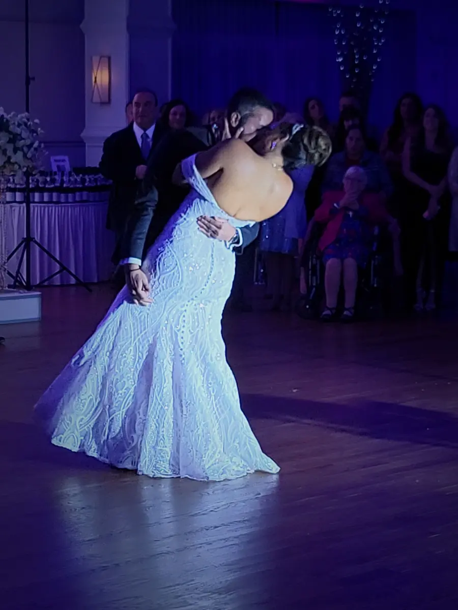 Bride wearing Bronson wedding dress by Sottero and Midgley dancing with her husband