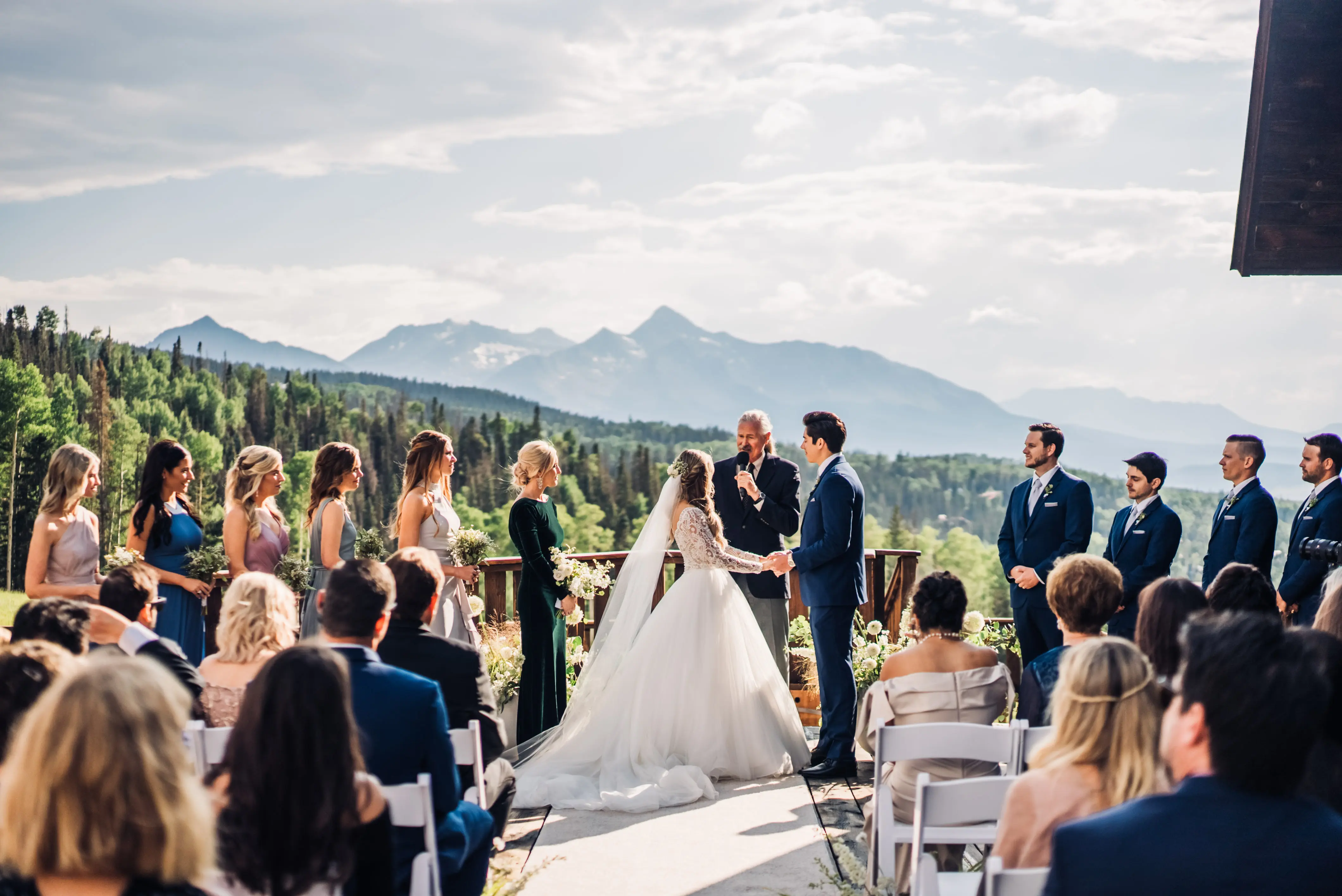 Bride with groom wearing long sleeve lace ballgown wedding dress