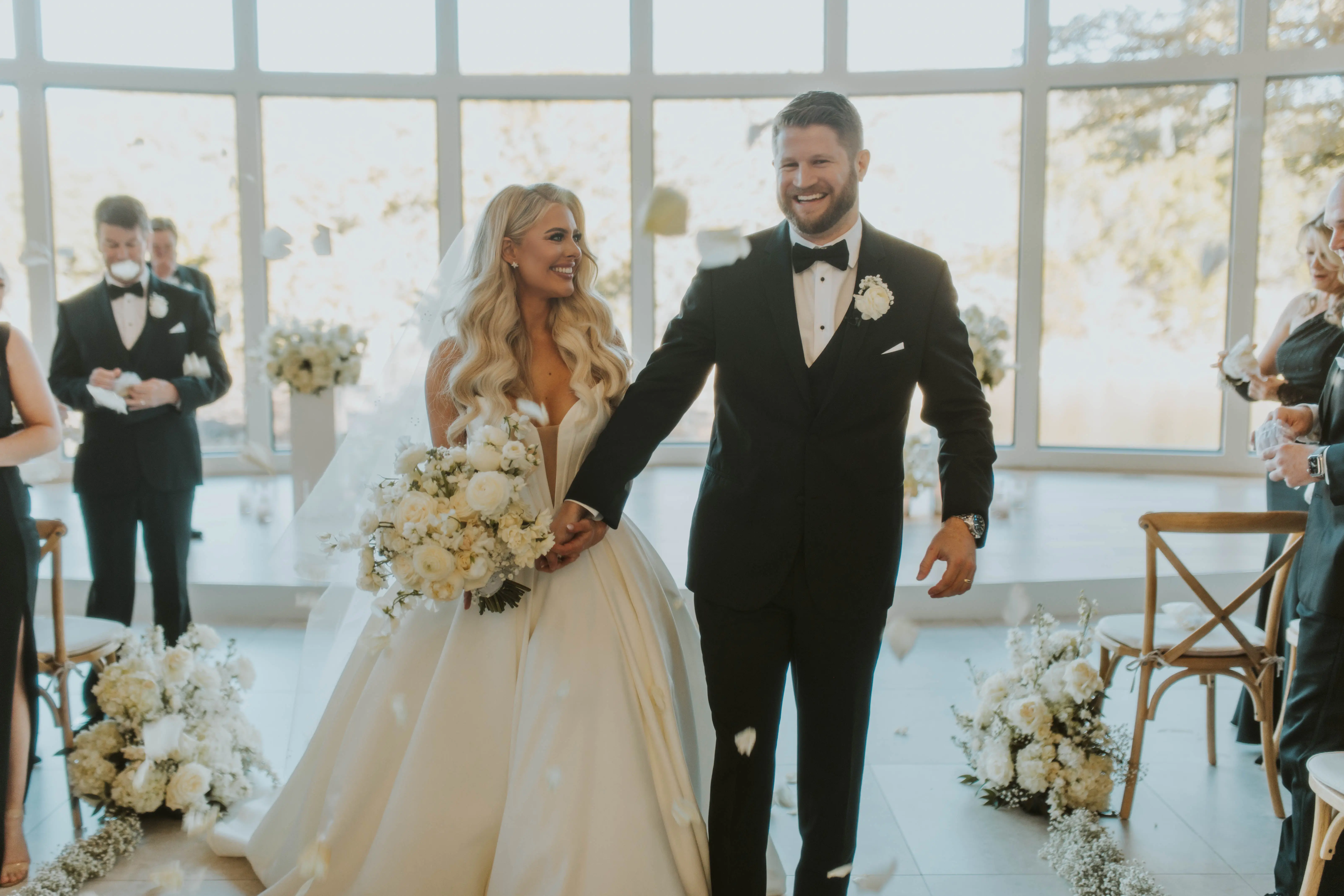 Bride wearing Derrick by Maggie Sottero at her ceremony with her husband