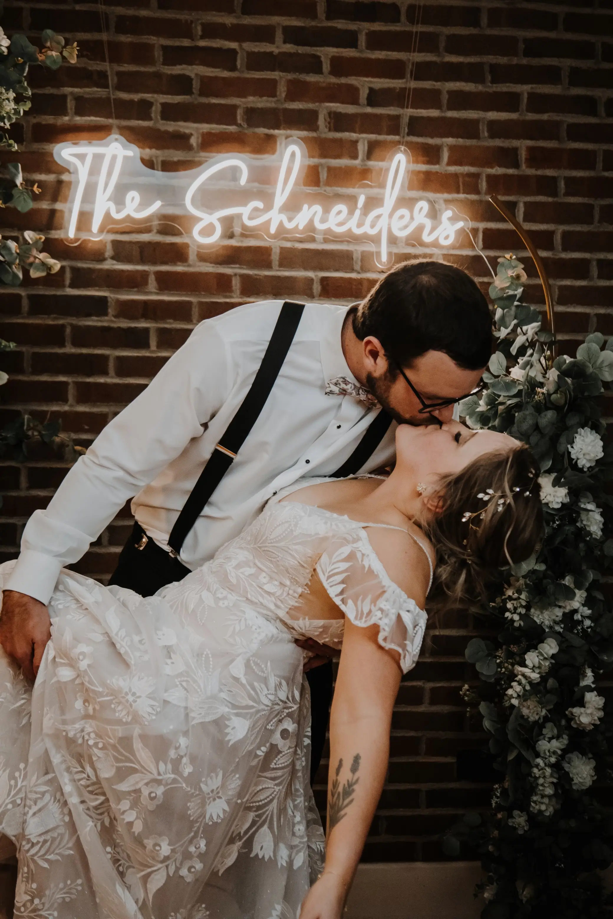Bride wearing Keisha wedding dress by Maggie Sottero kissing her husband
