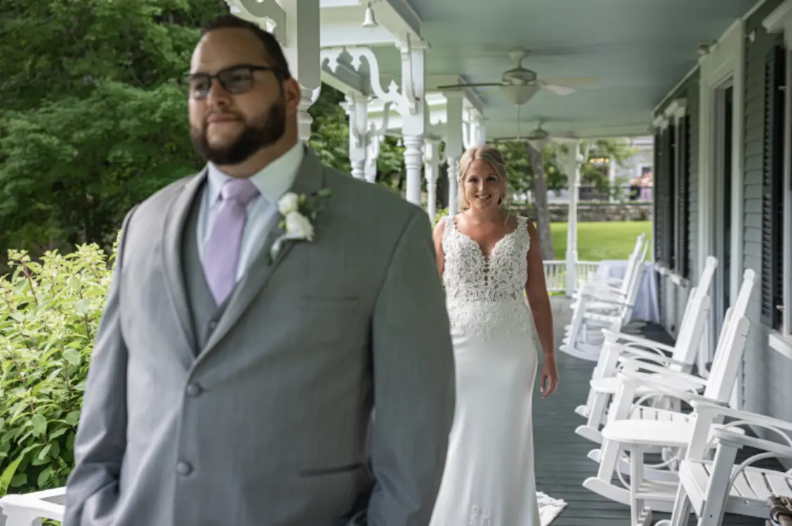 Bride with groom wearing lace crepe wedding dress