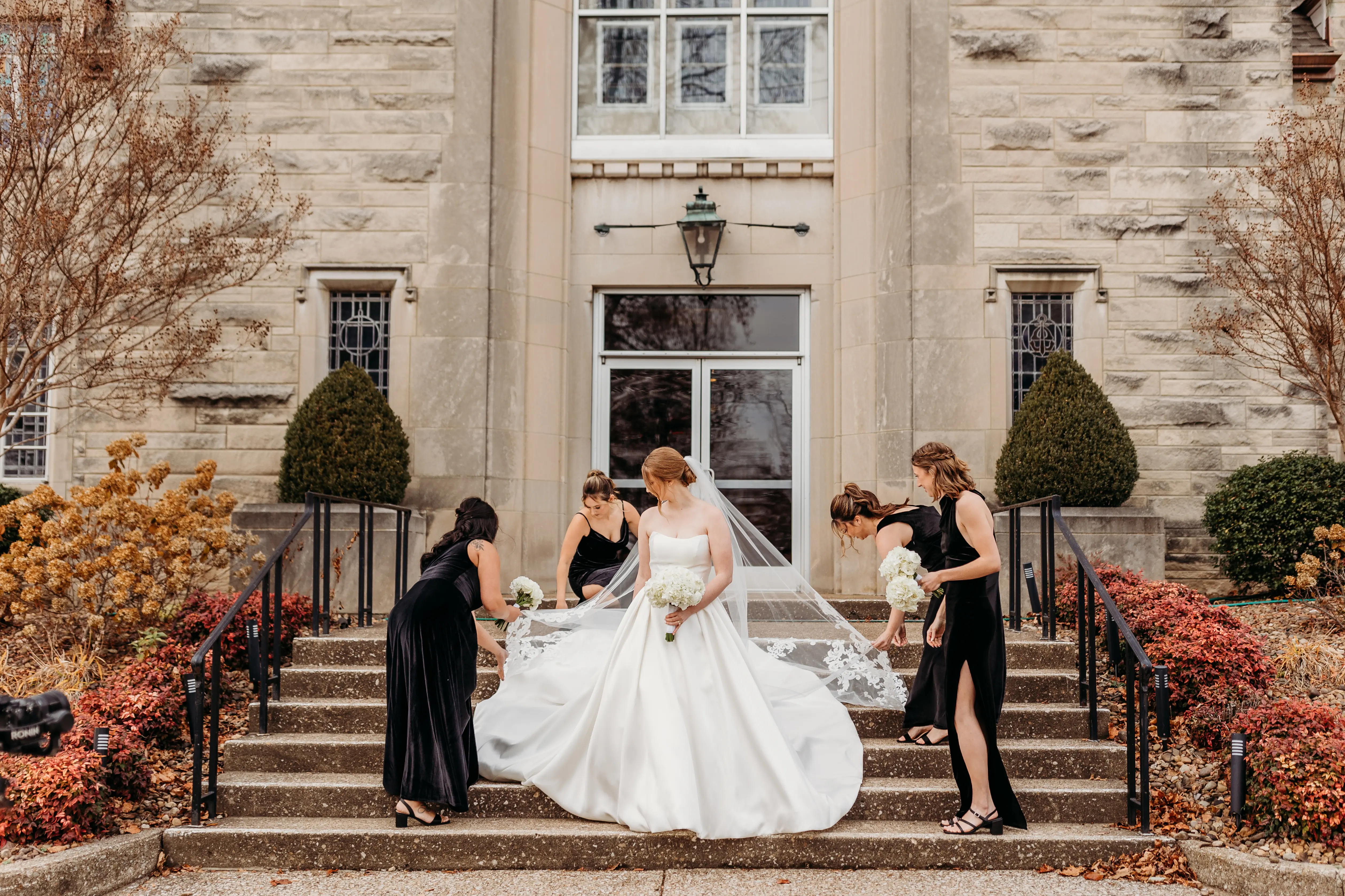 Bridesmaids With Bride In A Ball Gown White Wedding Dress Named Selena By Maggie Sottero And A Veil In The Fall
