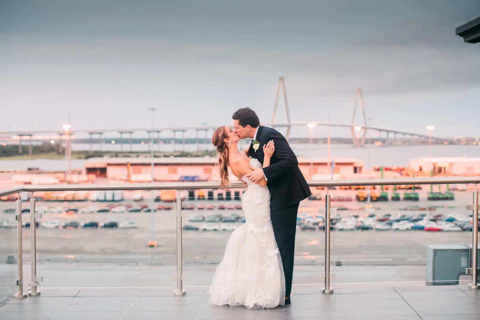 Bride with groom wearing strapless mermaid wedding dress with oversized lace