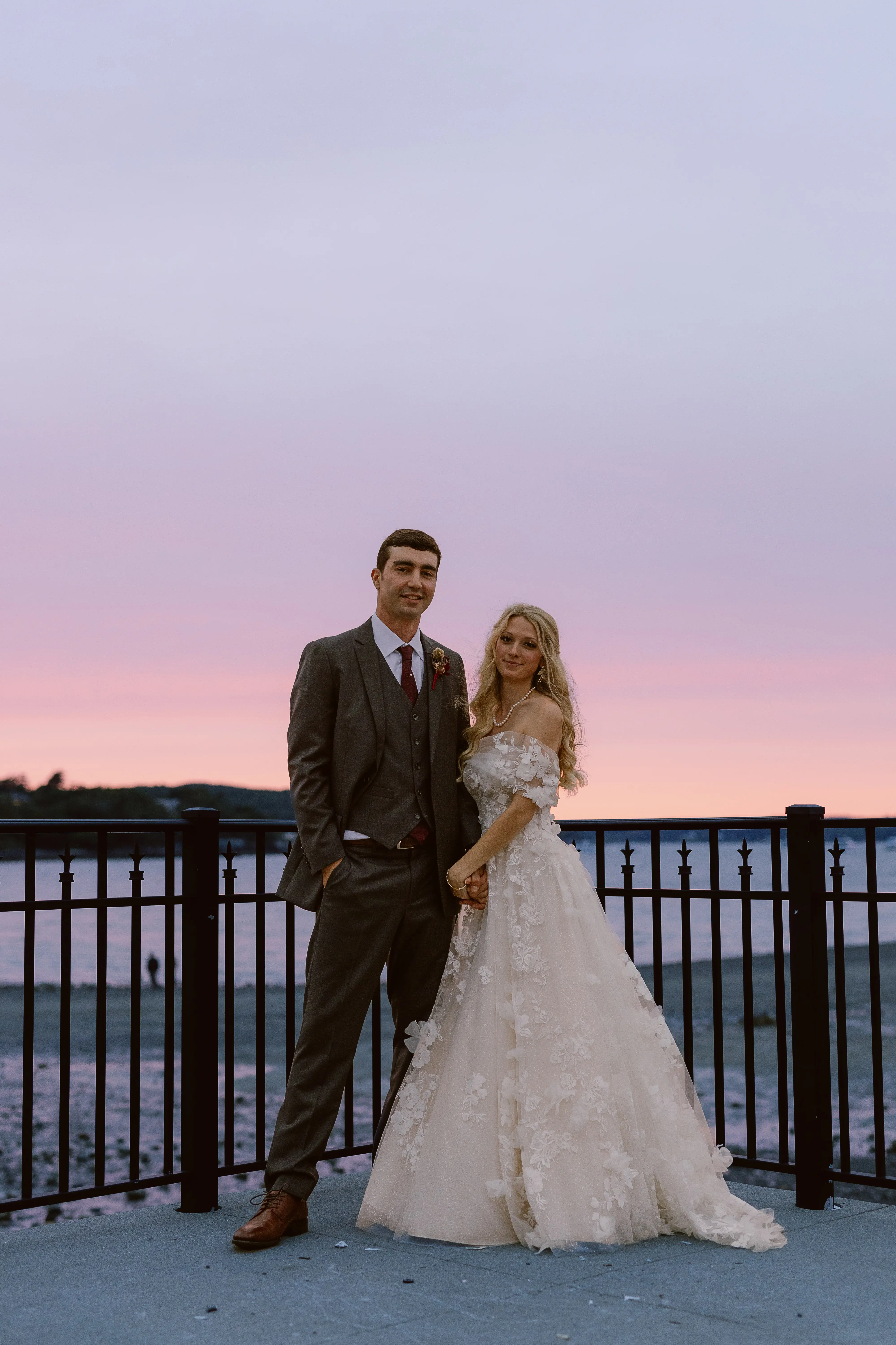 Bride wearing Laila wedding dress by Maggie Sottero standing with her husband