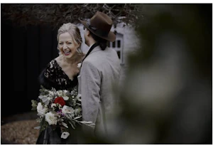 Bride Wearing Black Lace Wedding Gown Called Zander By Sottero and Midgley Laughing At Something The Groom Said