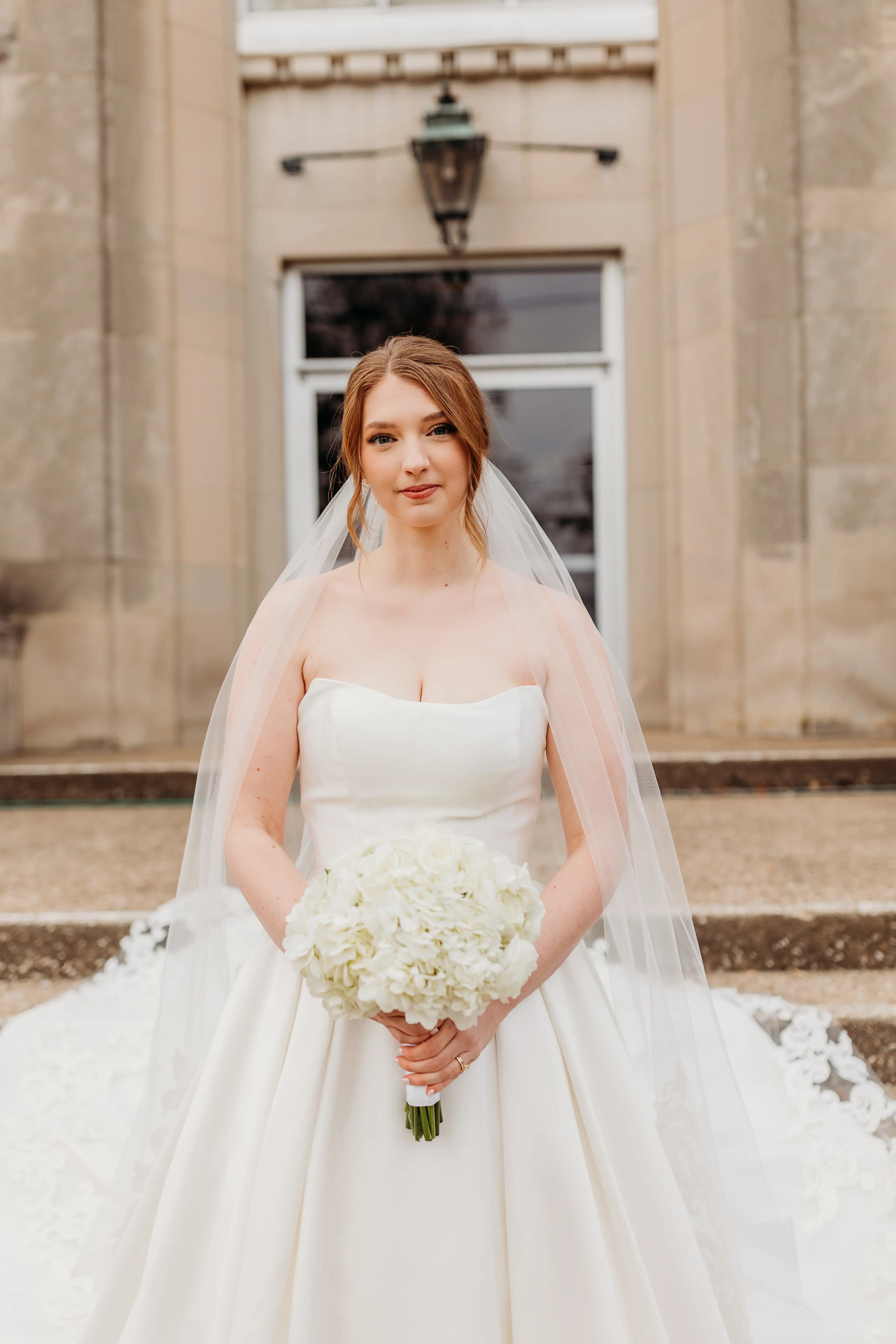 Real Bride Wearing A Strapless White Wedding Dress Named Selena By Maggie Sottero With Flowers