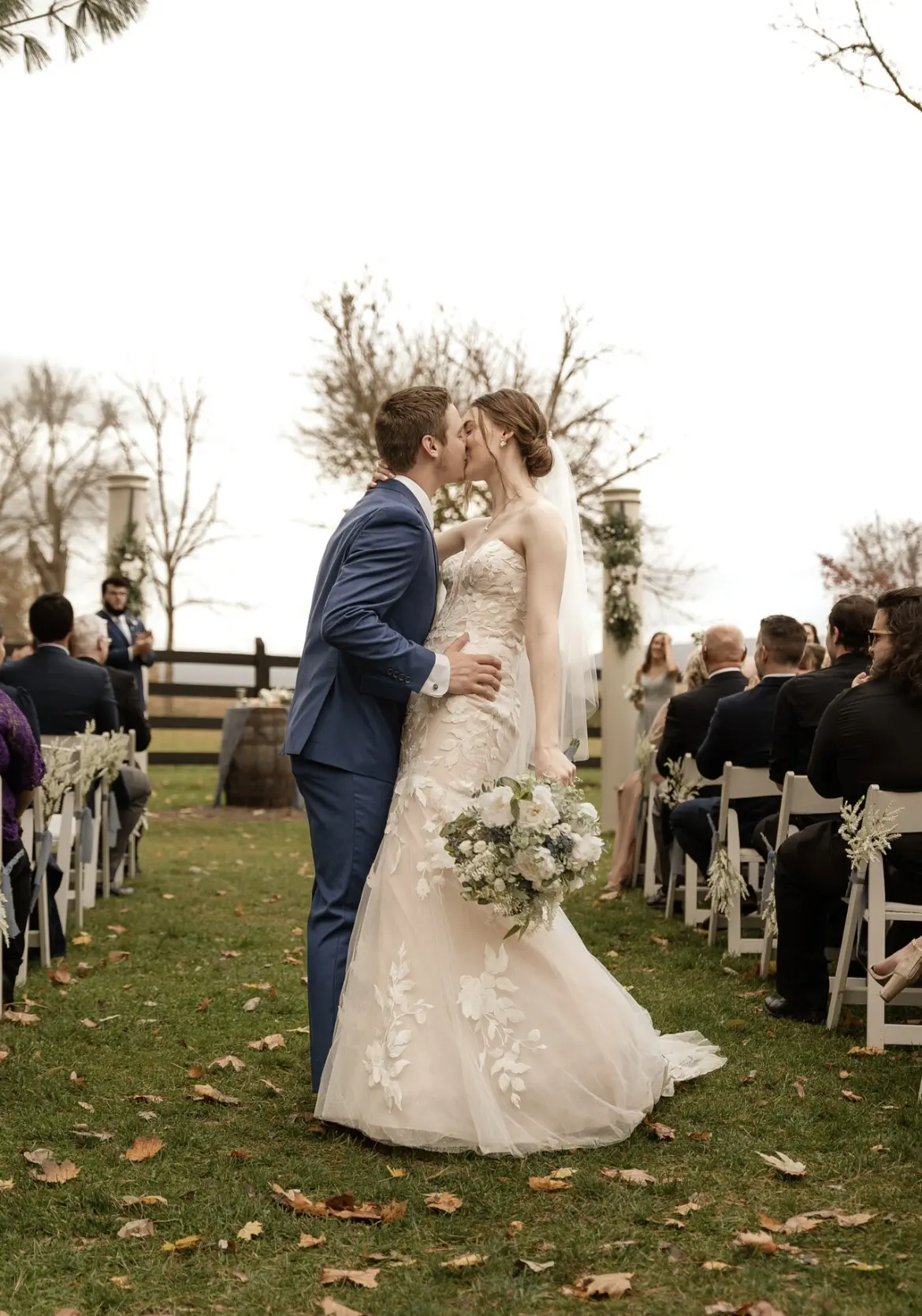 Bride And Groom Share Kiss Down The Aisle. Bride Wearing Sexy Strapless Wedding Dress Called Hattie By Rebecca Ingram
