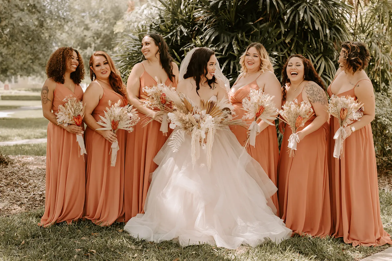 Bride with bridesmaids wearing strapless tulle ballgown wedding dress