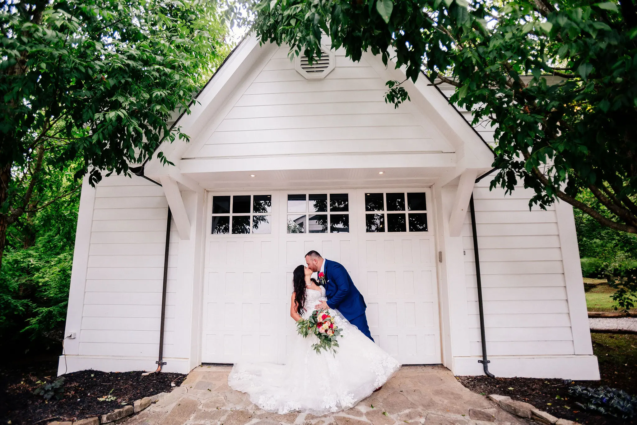 Groom dipping his bride wearing wedding dress called Valona.