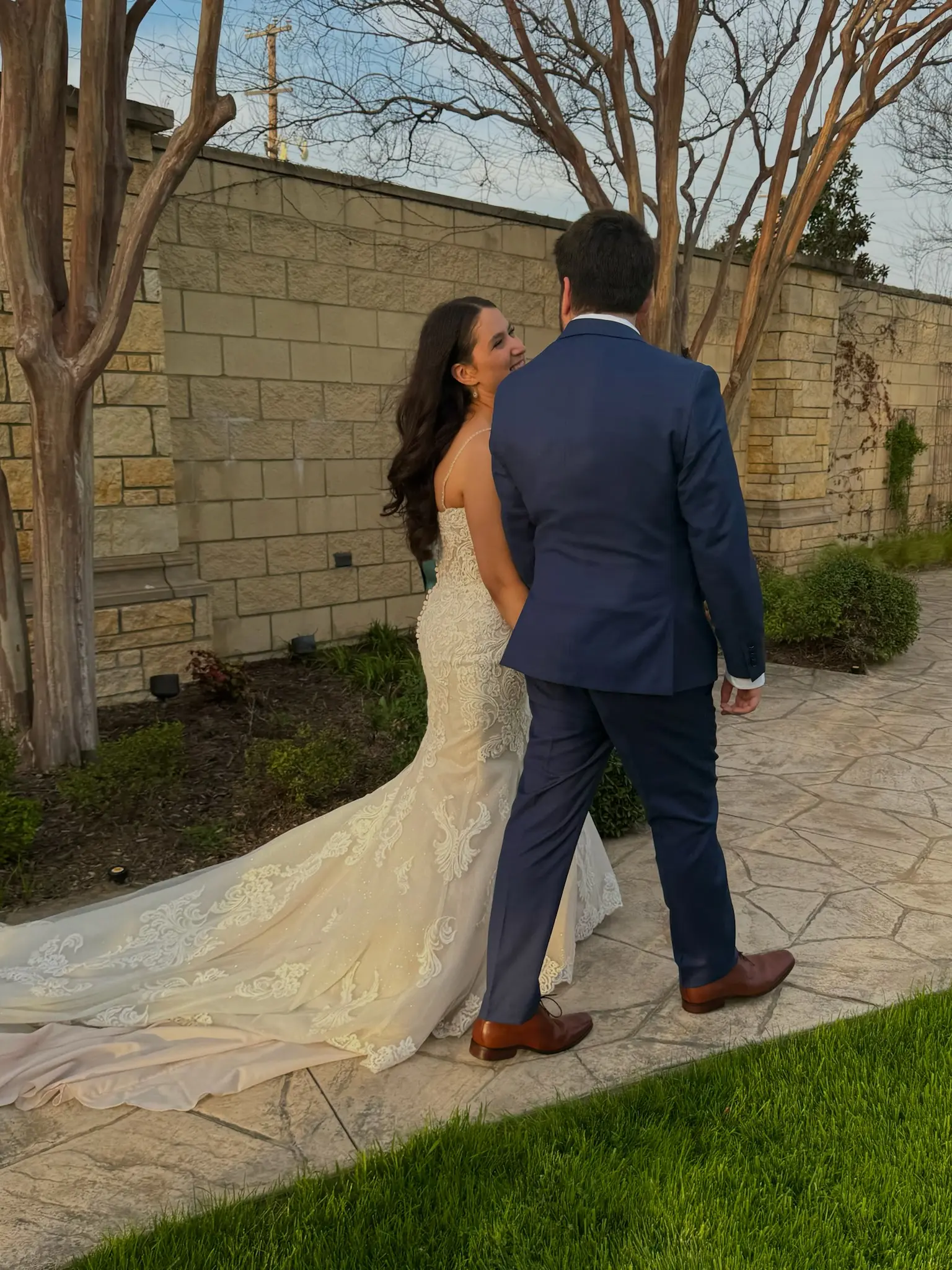 Bride Wearing Fit-n-Flare Wedding Dress Called Fiona By Maggie Sottero Walking With Groom