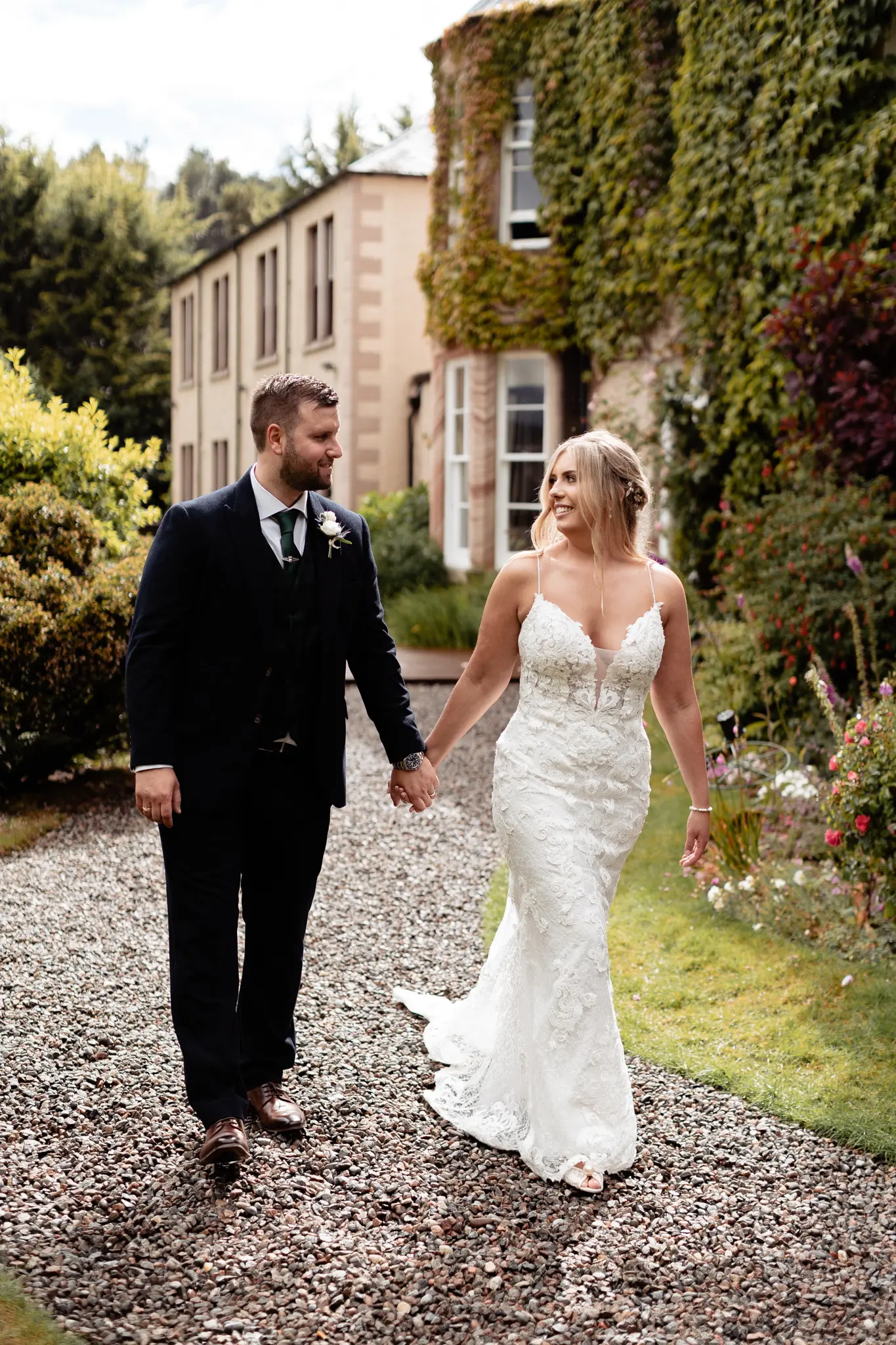 Groom with Bride in Romantic Lace Sheath Wedding Gown with Shimmering Lace Motifs Called Tuscany Lynette by Maggie Sottero