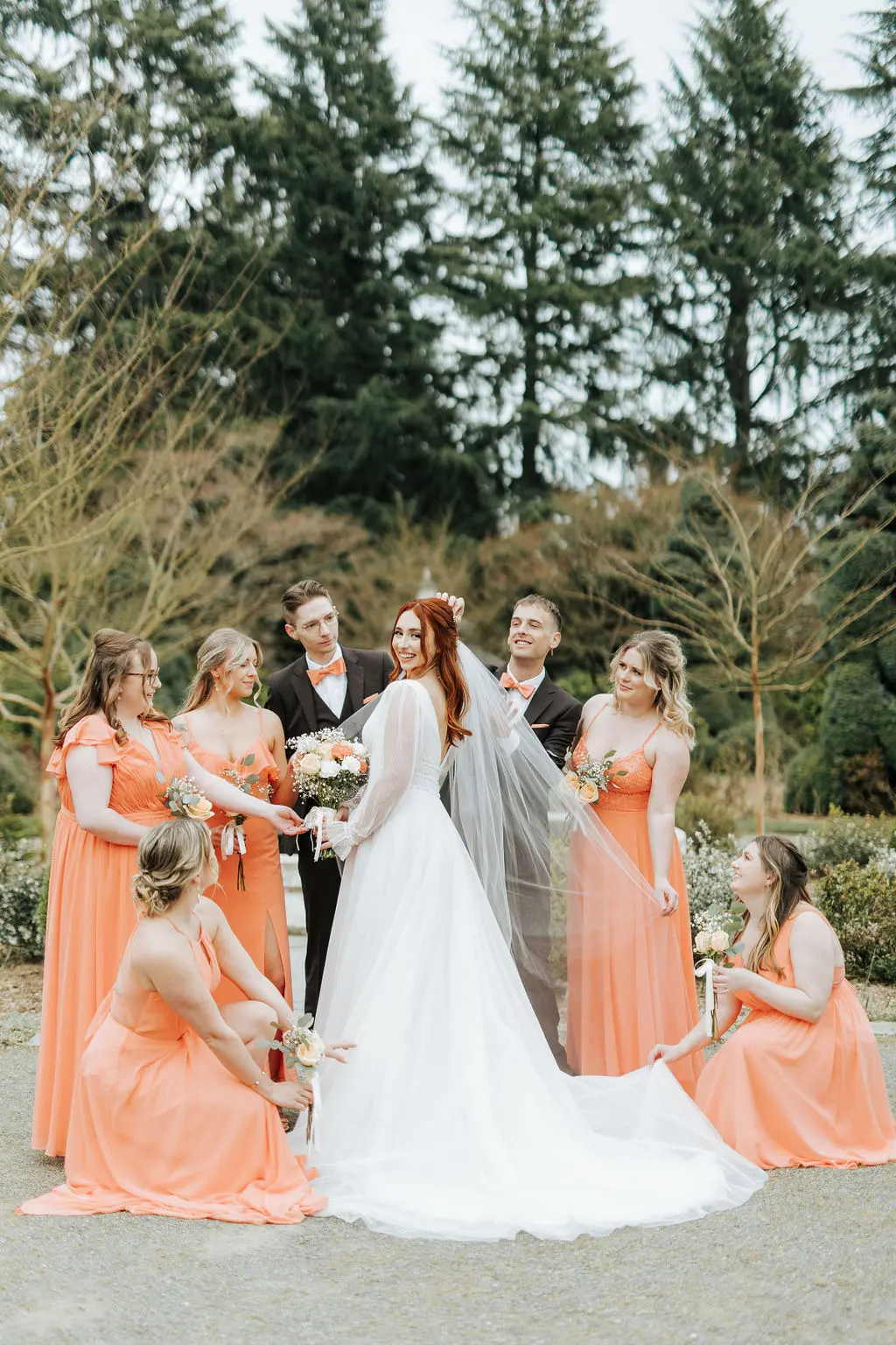 Bride Wearing Sexy Long Sleeve A-Line Wedding Dress Outdoors with Bridesmaids.