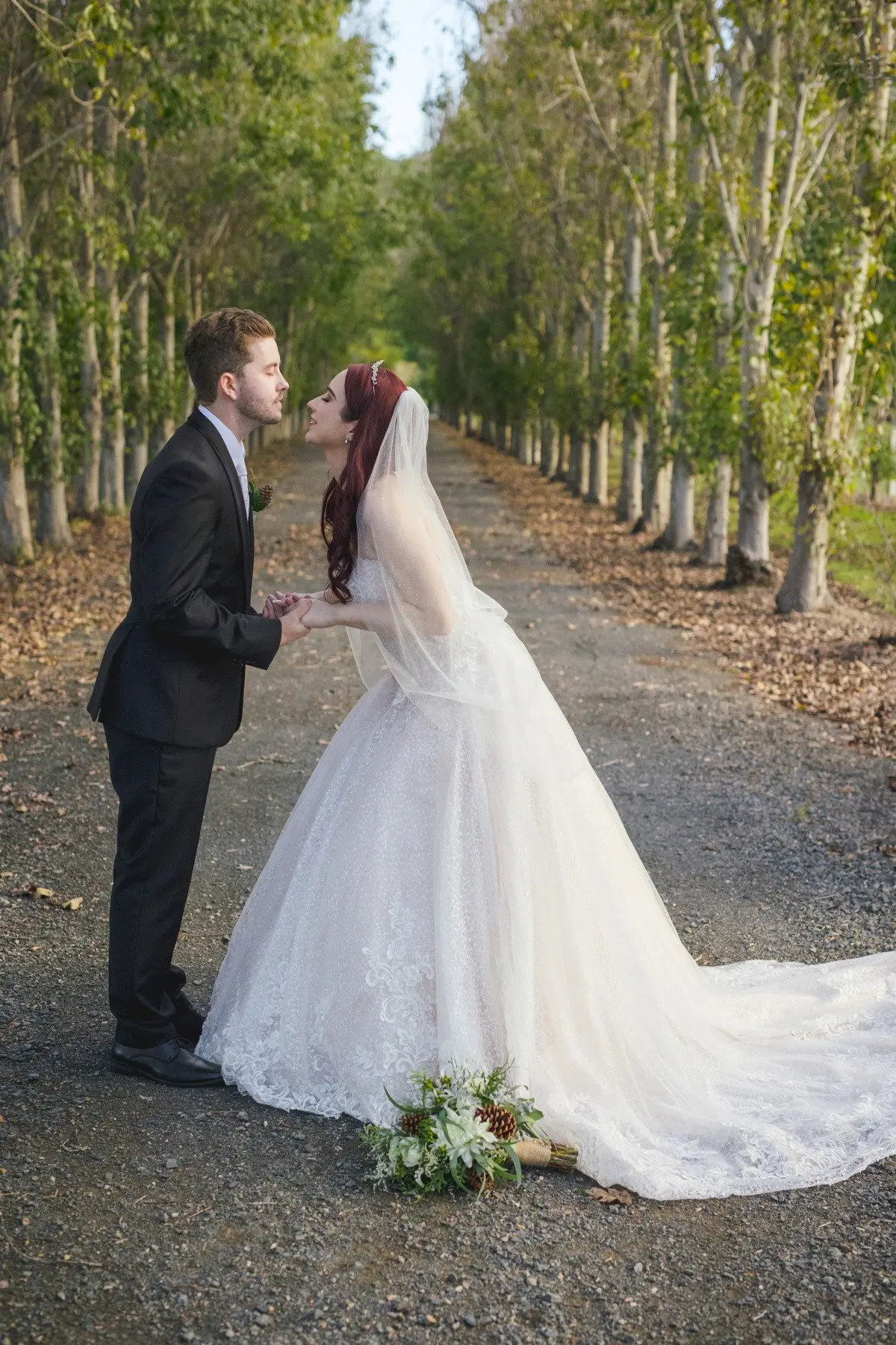 Groom with Bride in Lace Ball Gown Wedding Dress with Sequined Tulle and Lace Motifs over Bodice and Statement Hemline called Tristyn by Maggie Sottero