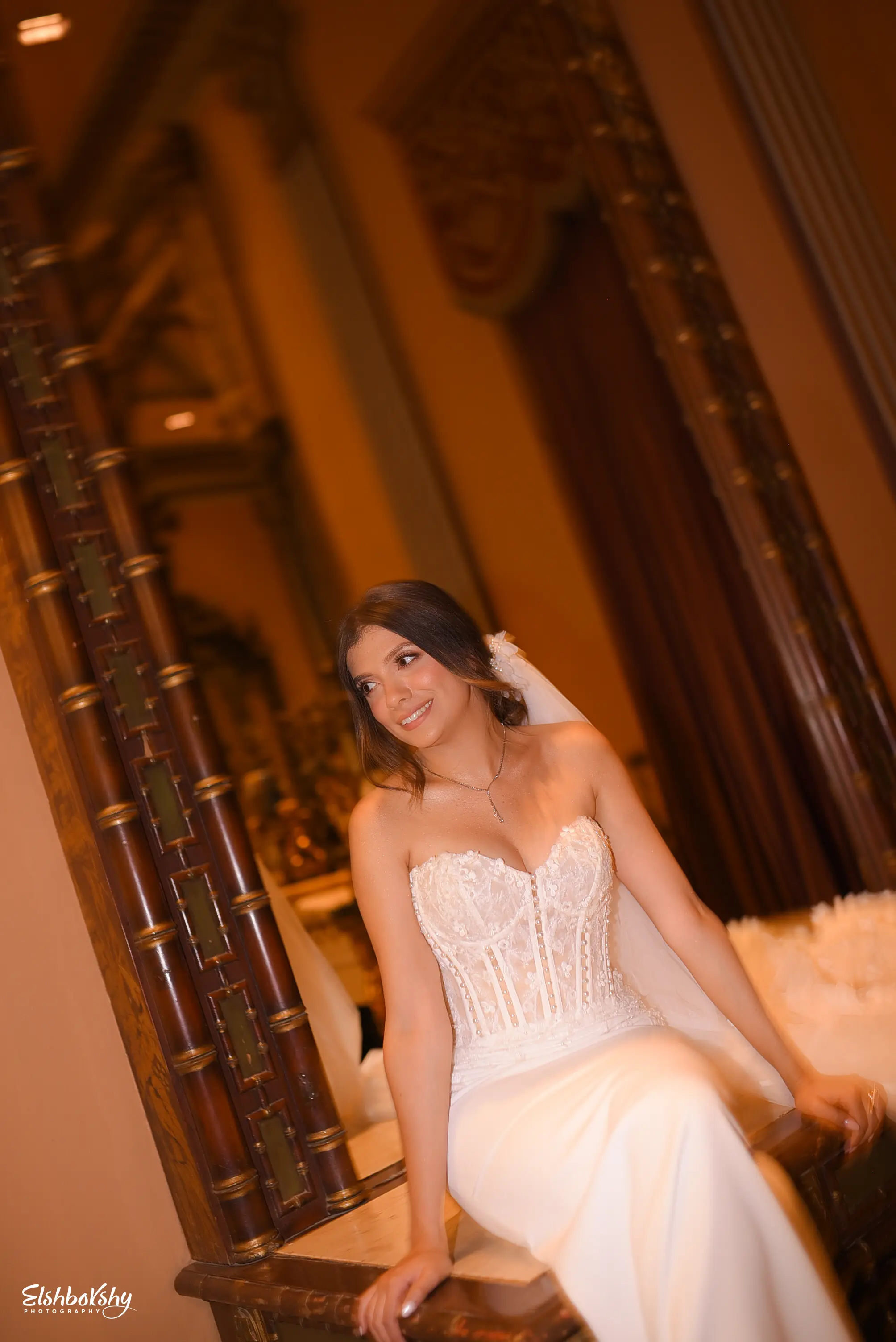 Bride Wearing Sheath and Beaded Wedding Dress Called Doritte By Maggie Sottero Sitting In Front Of A Mirror